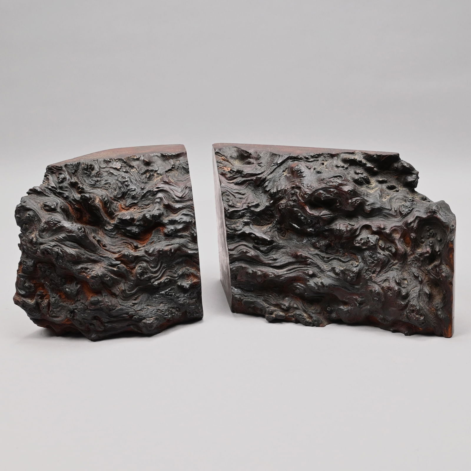 Pair of Redwood Burl Bookends: Pair of Redwood Burl Bookends. The burl cut in half to create the two ends. Largest half: H: 5.5 in., W: 10.25 in., D: 4.375 in.