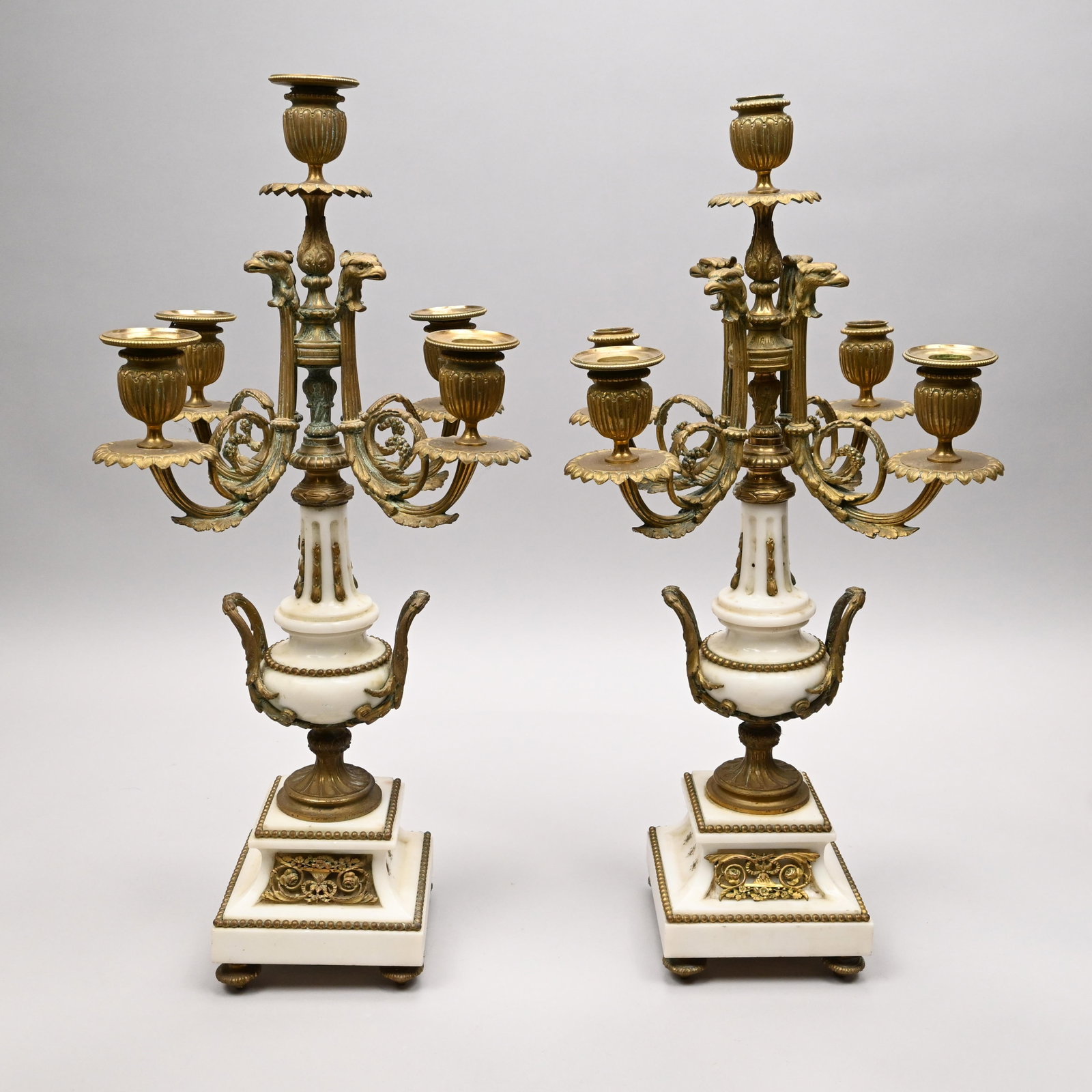 Pair Louis XV Style Gilt-Metal & Marble Candelabra: Pair of Louis XV Style Gilt-Metal and White Marble Five-Light Candelabra, Late Nineteenth Century. Each white marble urn raised on a stepped square base fitted with, issuing a knopped standard ending 