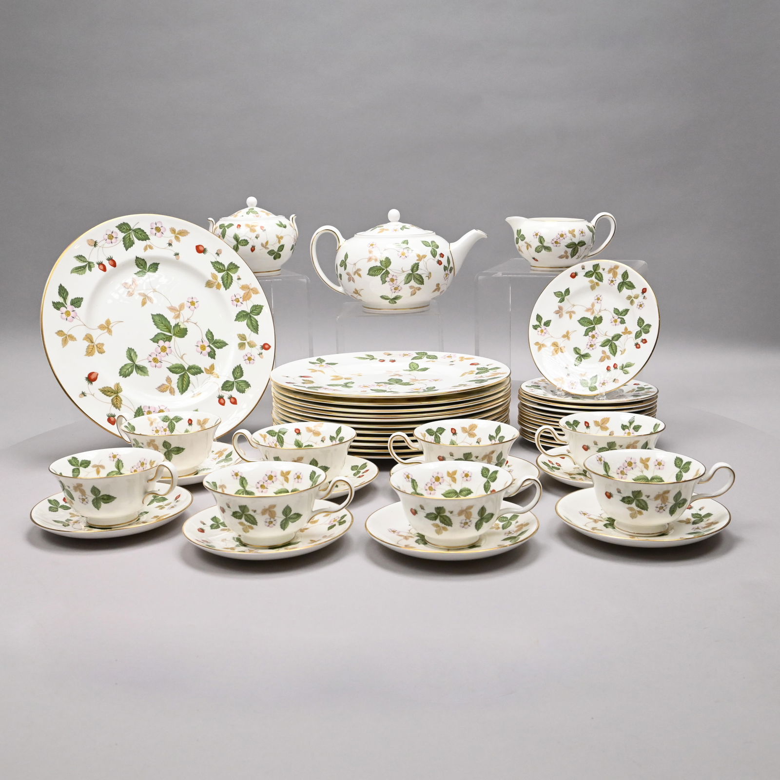 Wedgwood Bone Chine 'Wild Strawberry' Part Service: Wedgwood Bone Chine 'Wild Strawberry' Part Service, Second Half Twentieth Century. Comprising twelve 10.75- inch dinner plates, twelve bread and butter plates, eight teacups and eight saucers, teapot,