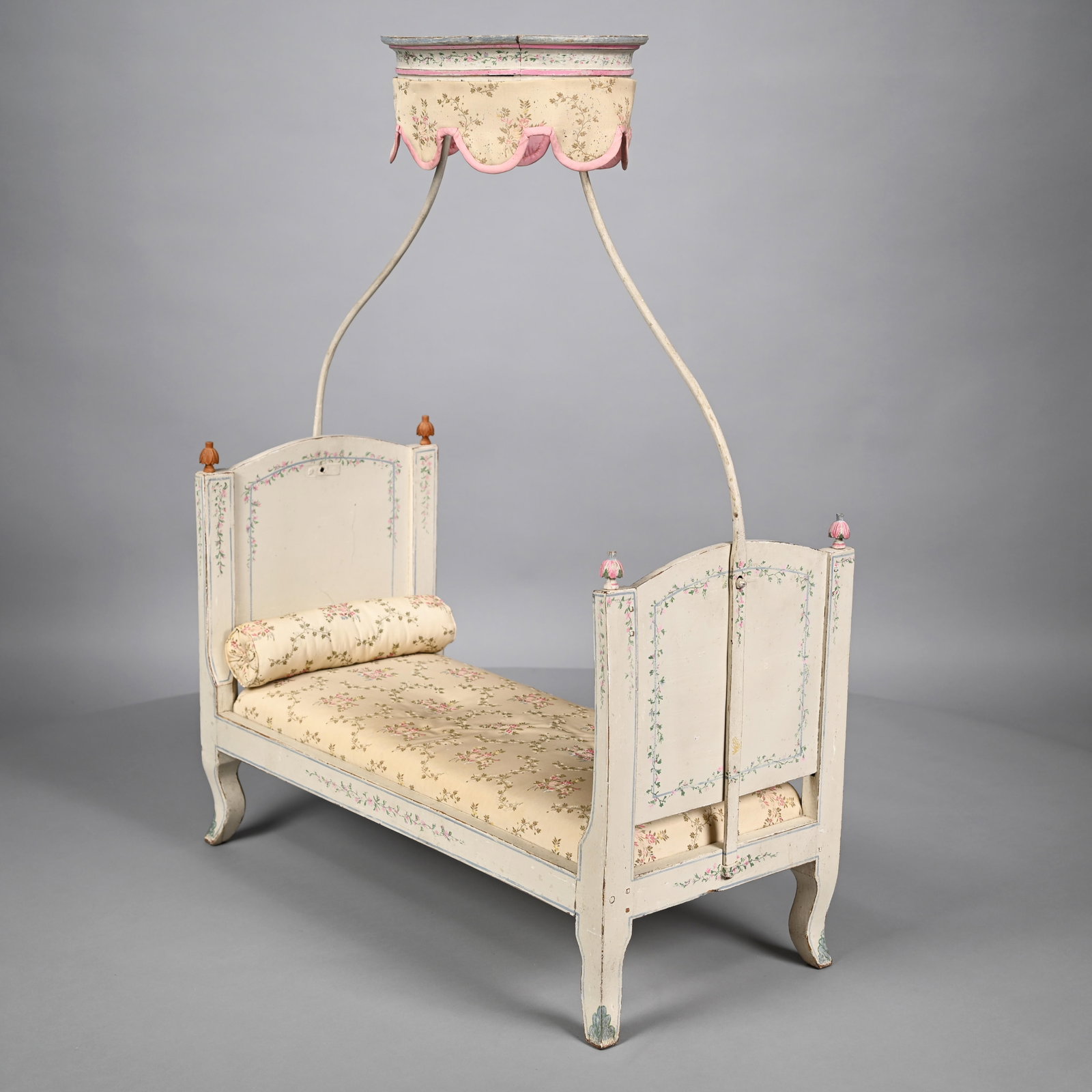 Louis XV StyleProvincial Doll's Baldaquin Bedstead: Louis XV Style Provincial Painted Wood Doll's Baldaquin Bedstead. In cream paint, the head and footboard each within posts surmounted by leaf finials, raised on cabriole legs; the whole painted in out