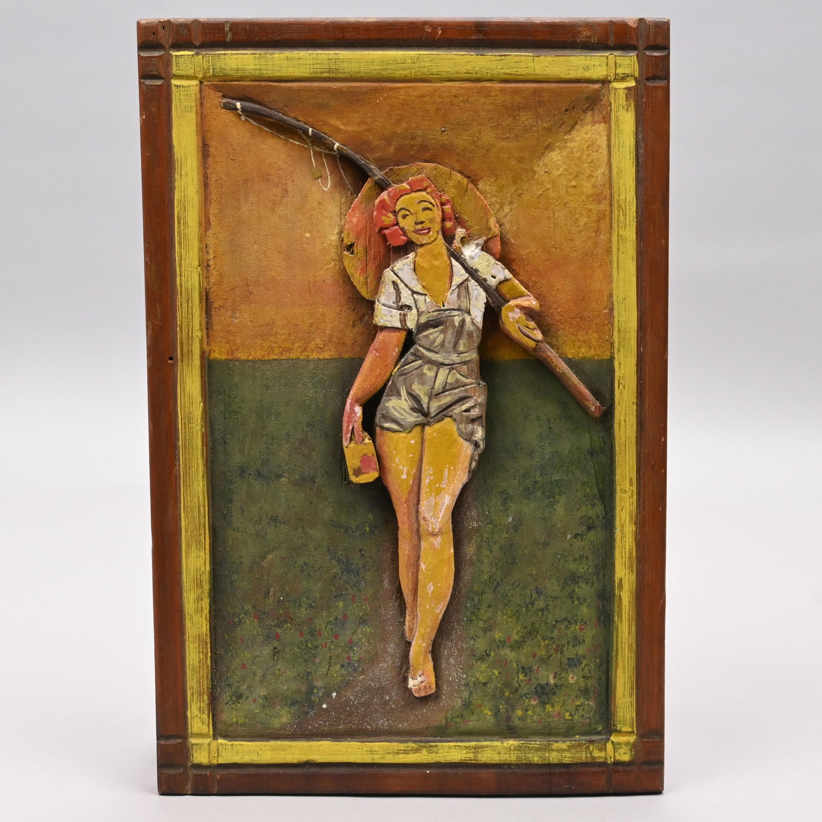 Carved & Painted Plaque, Woman Going Fishing: Carved and Painted Plaque Depicting a Woman Going Fishing, Mid-Twentieth Century. H: 12.375 in., W: 8.25 in., D: .625 in.