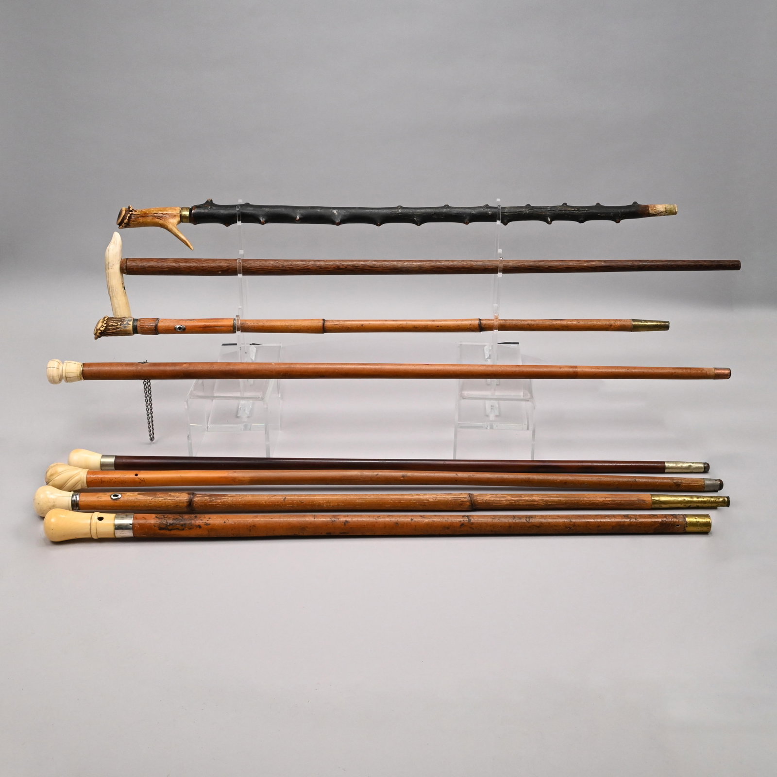 Eight American and English Walking Sticks: Eight American and English Walking Sticks, Mid-Late Nineteenth Century. Affixed with various antler and bone grips, one engraved on the collar "W Brigham." Longest: L: 38.125 in., W: 6 in. Provenance: