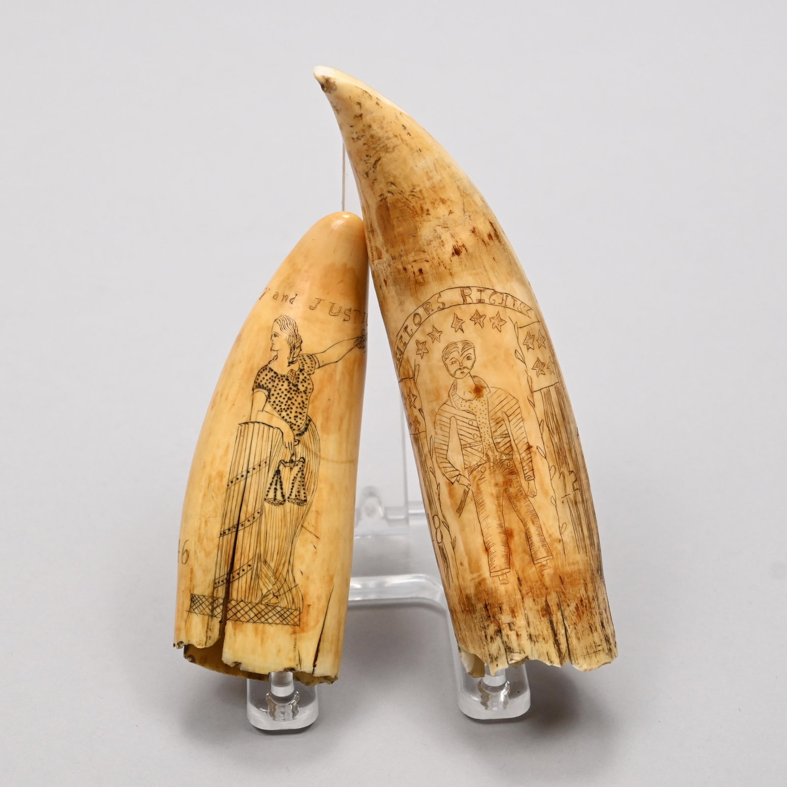 Two Scrimshaw Whale's Teeth,Mid-Nineteenth Century: Two Scrimshaw Whale's Teeth, Mid-Nineteenth Century. The first engraved "LIBERTY and JUSTICE" around the tip, and on one side with a compass above the Great Seal of the United States, the flag and arr