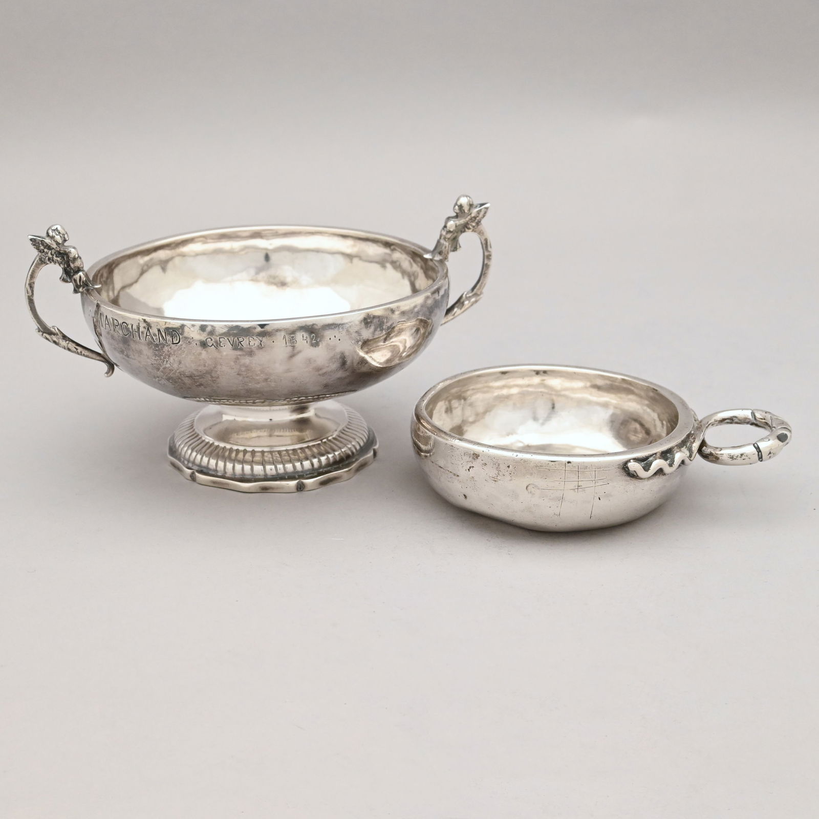 French Silver Wine Taster and a Caudle Cup: French Silver Wine Taster and a Caudle Cup. The wine taster affixed with a double snake entwined handle, engraved around the rim "MICHEE PAILLIOUX D ST G" in hatched block letters, guarantee and maker