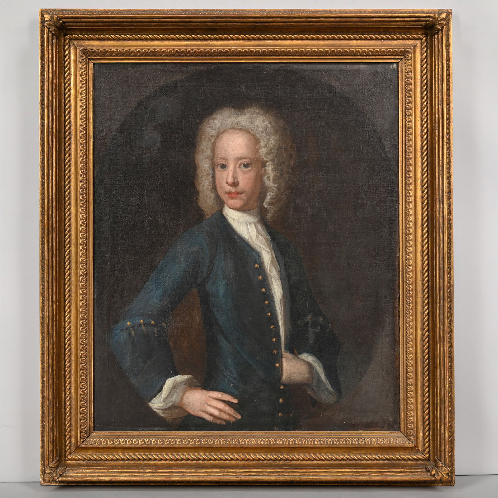 British or American School-Portrait of a Gentleman: British or American School. Portrait of a Gentleman, Eighteenth Century. Oil on canvas, the gentleman depicted half-length with one hand inside his coat and gazing at the viewer, wearing a powdered wi