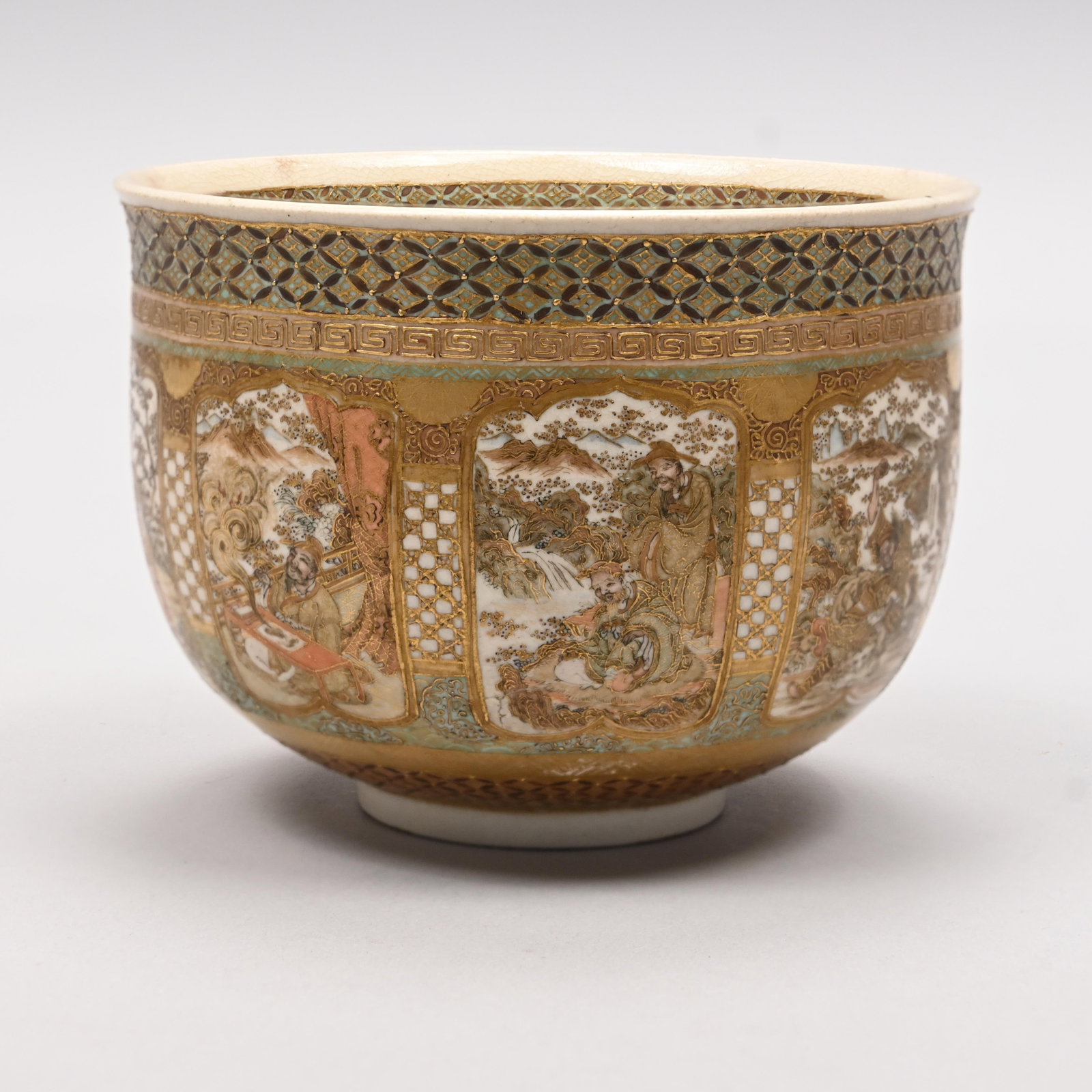 Japanese Satsuma Porcelain Bowl, Meiji Period: Japanese Satsuma Porcelain Bowl, Meiji Period (1868-1912). The exterior surrounded by eight shaped panels enclosing figures (possibly from legends) engaged in various activities, beneath a gold Greek 