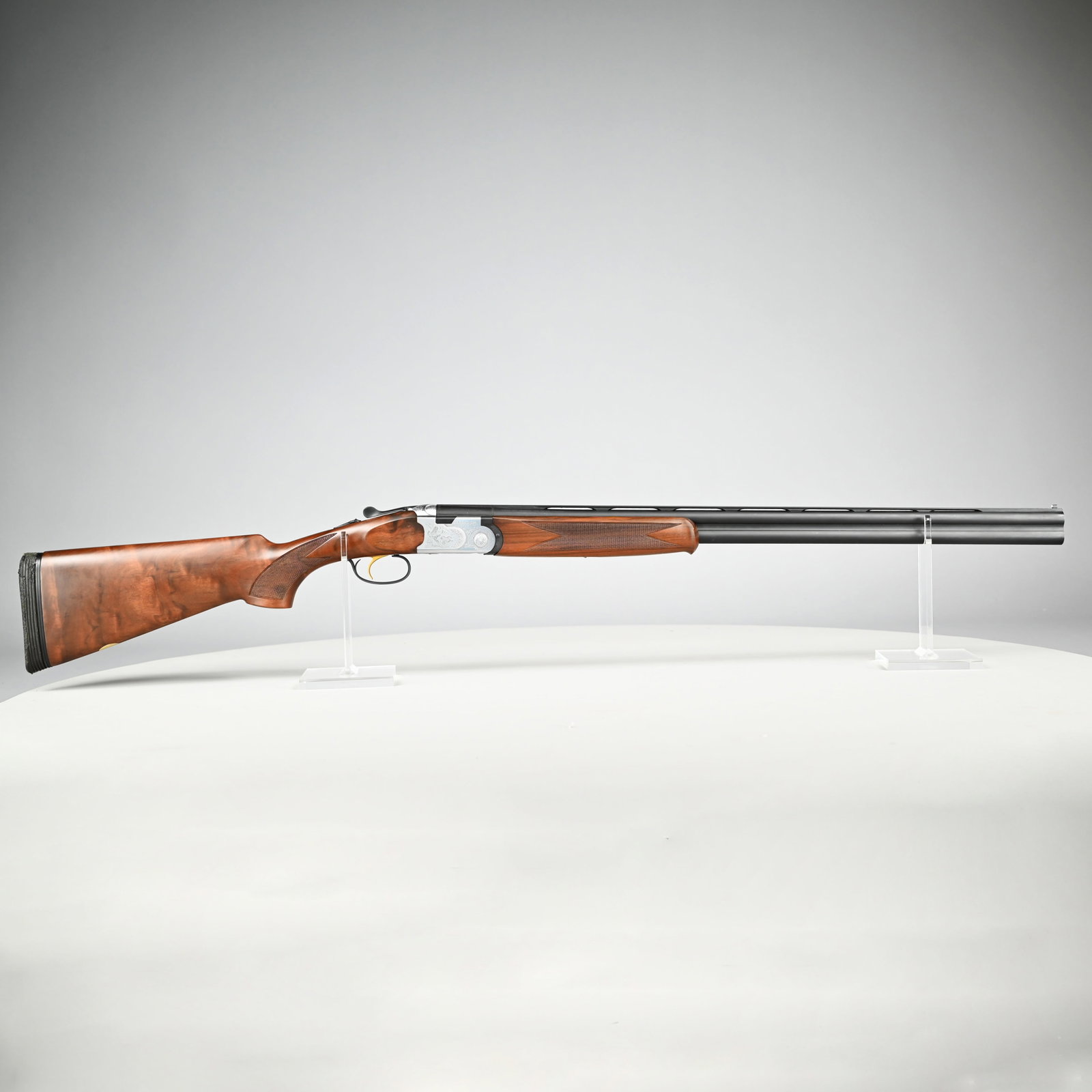 Beretta S687 Silver Pigeon Sporting 20 Gauge O/U: Beretta S687 Silver Pigeon Sporting 20 Gauge Over/Under Shotgun. Serial #M27519B, 2 3/4- and 3-inch shells, the receiver engraved with pairs of game birds, waterfowl and floral scrollwork, flowerhead 