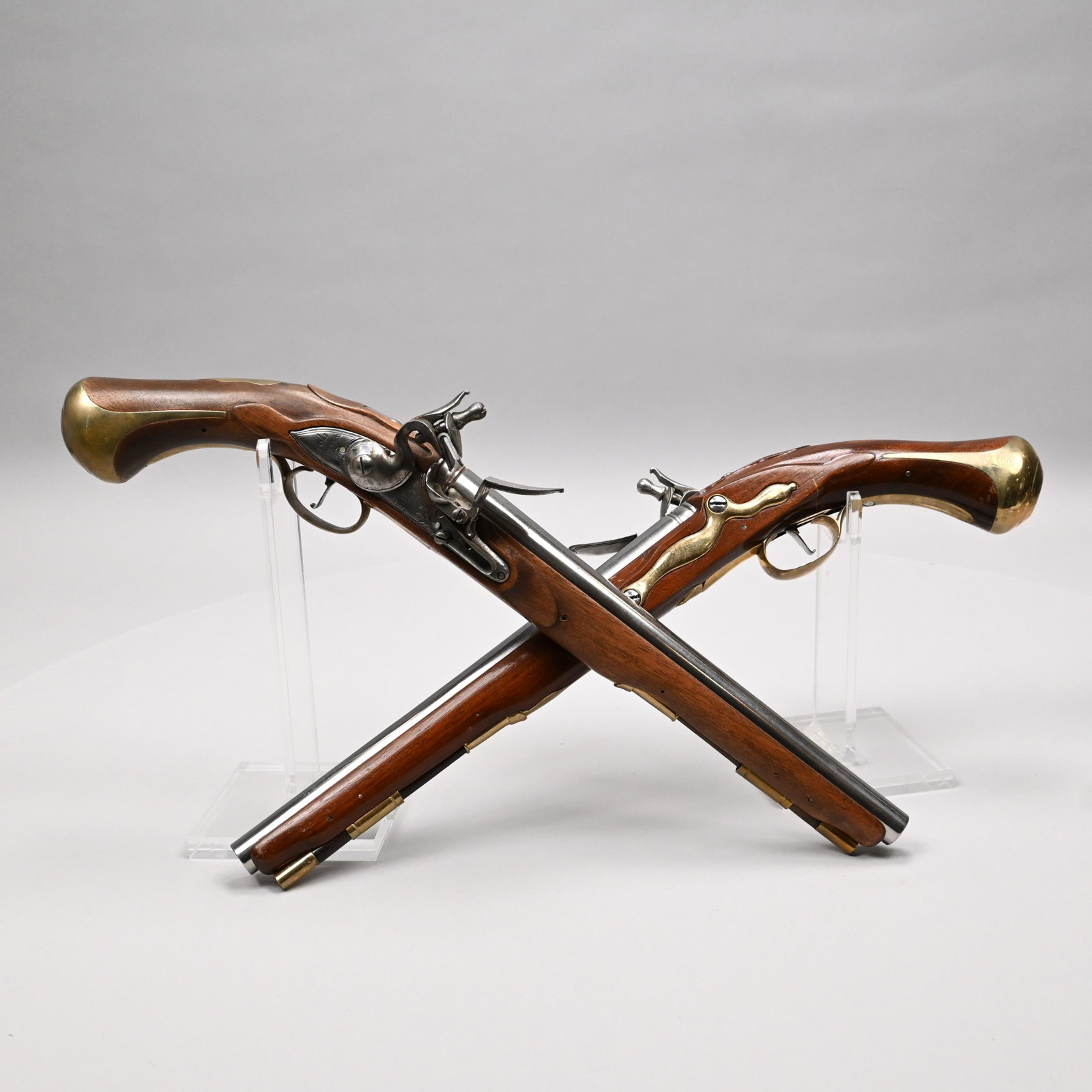 Pair Flintlock Pistols for Colonial Williamsburg: Pair of Mahogany, Brass and Polished Steel Replicas of Flintlock Pistols. (Functioning but non-firing). Each lock plate engraved with the British crown above "GR," and "WILETS 1761." H: 2 in., W: 19.2