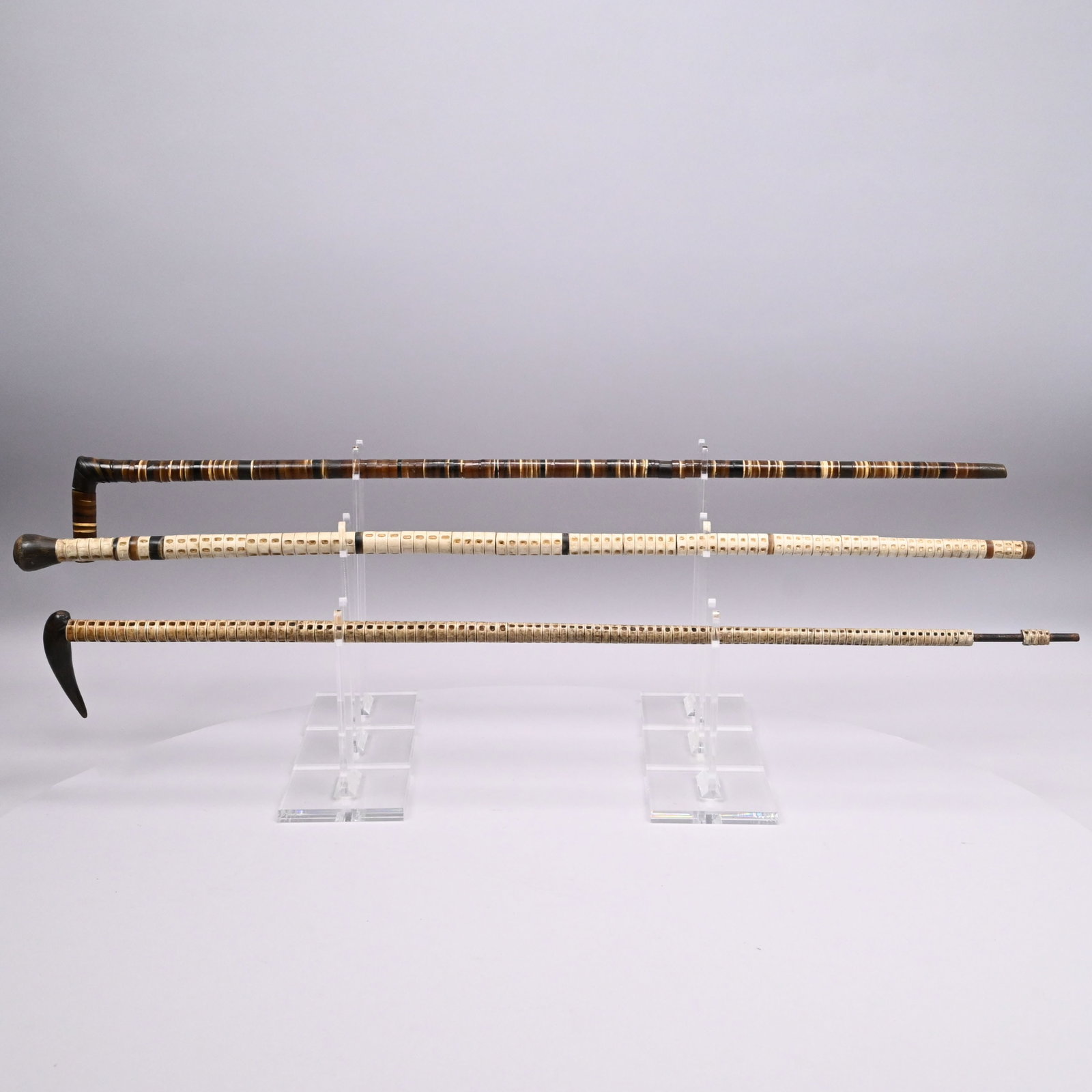Three Scrimshaw Walking Sticks: Three Scrimshaw Walking Sticks, Mid-Nineteenth and Early Twentieth Century. Comprising a shark vertebrae steel shaft walking stick with horn grip; a whalebone, baleen and horn walking stick with brass