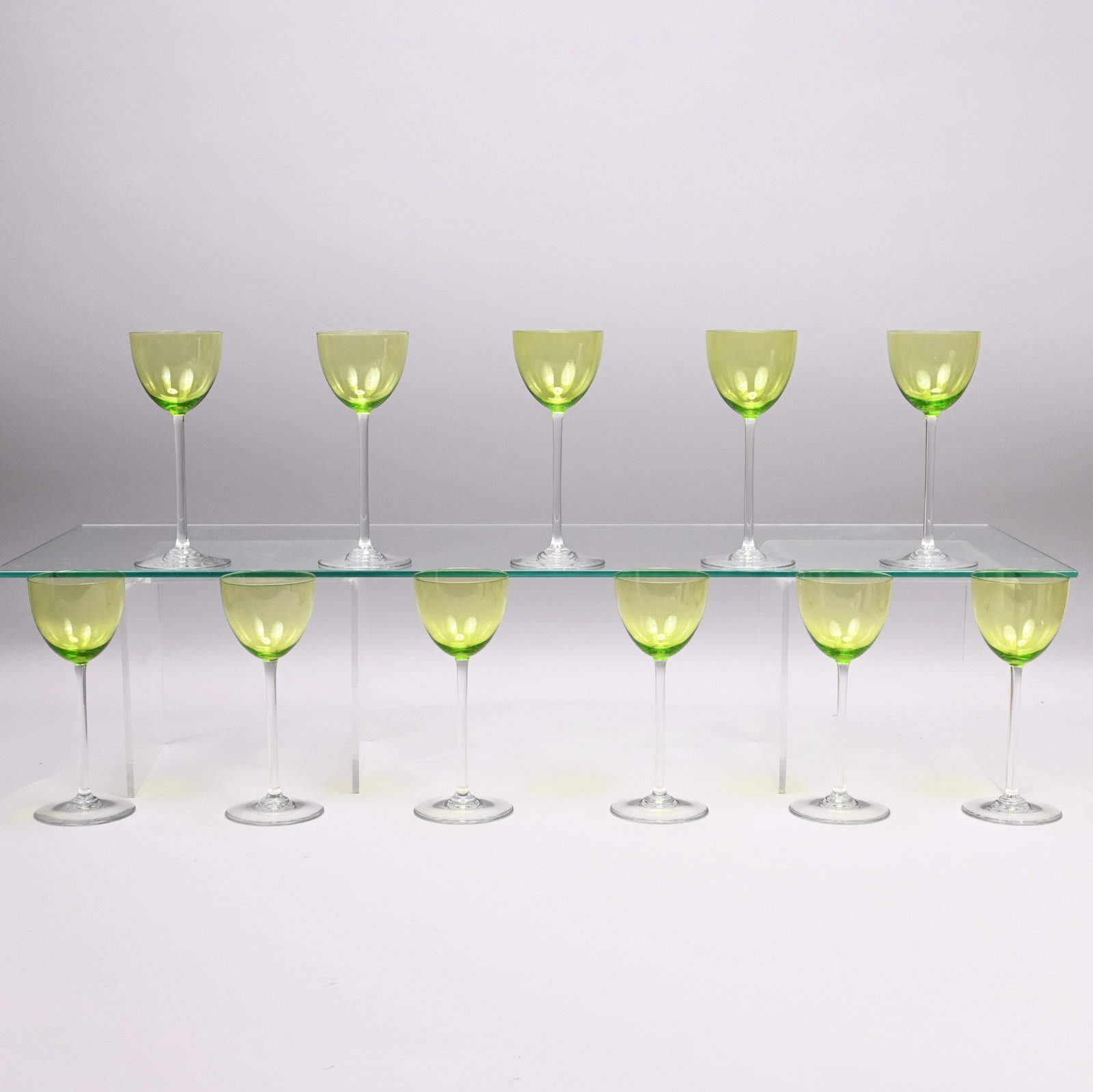 Set of Eleven French Hock Glasses,Baccarat Crystal: Set of Eleven French Chartreuse and Colorless Glass Hock Glasses, Baccarat Crystal, Twentieth Century. Each pale green bowl above a tall cylindrical stem and circular foot, each acid etched with the "