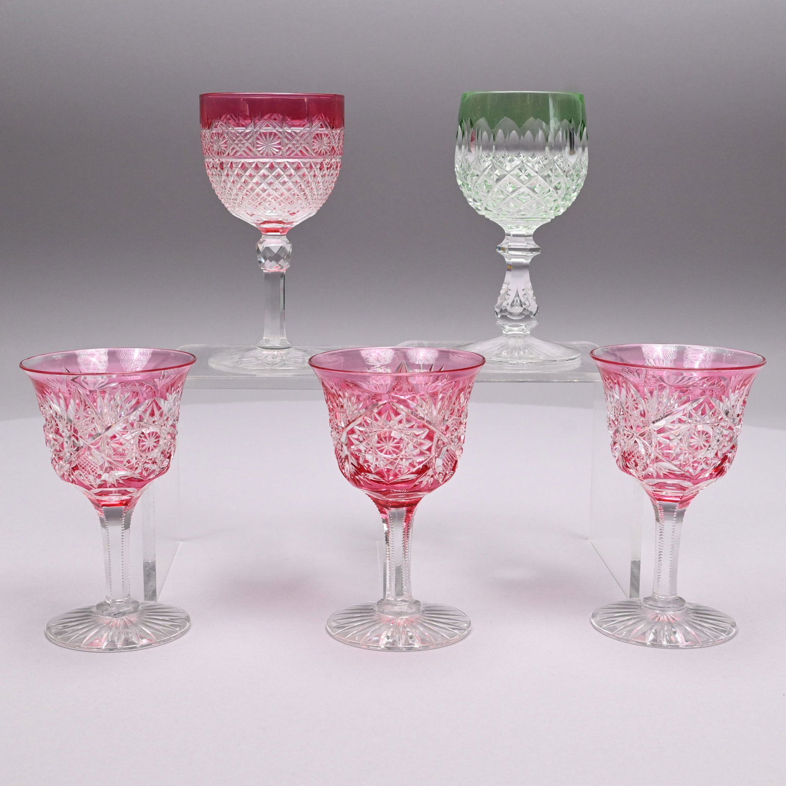 Set of Three Wine Glasses, Hoare & Two Single Exam: Set of Three American Cranberry Flashed Cut Glass 'Monarch' Pattern Wine Glasses, Attributed to John Hoare & Co., Corning, New York, 1895 - 1900 and Two Single Flashed Cut Glass Wine Glasses. The set 