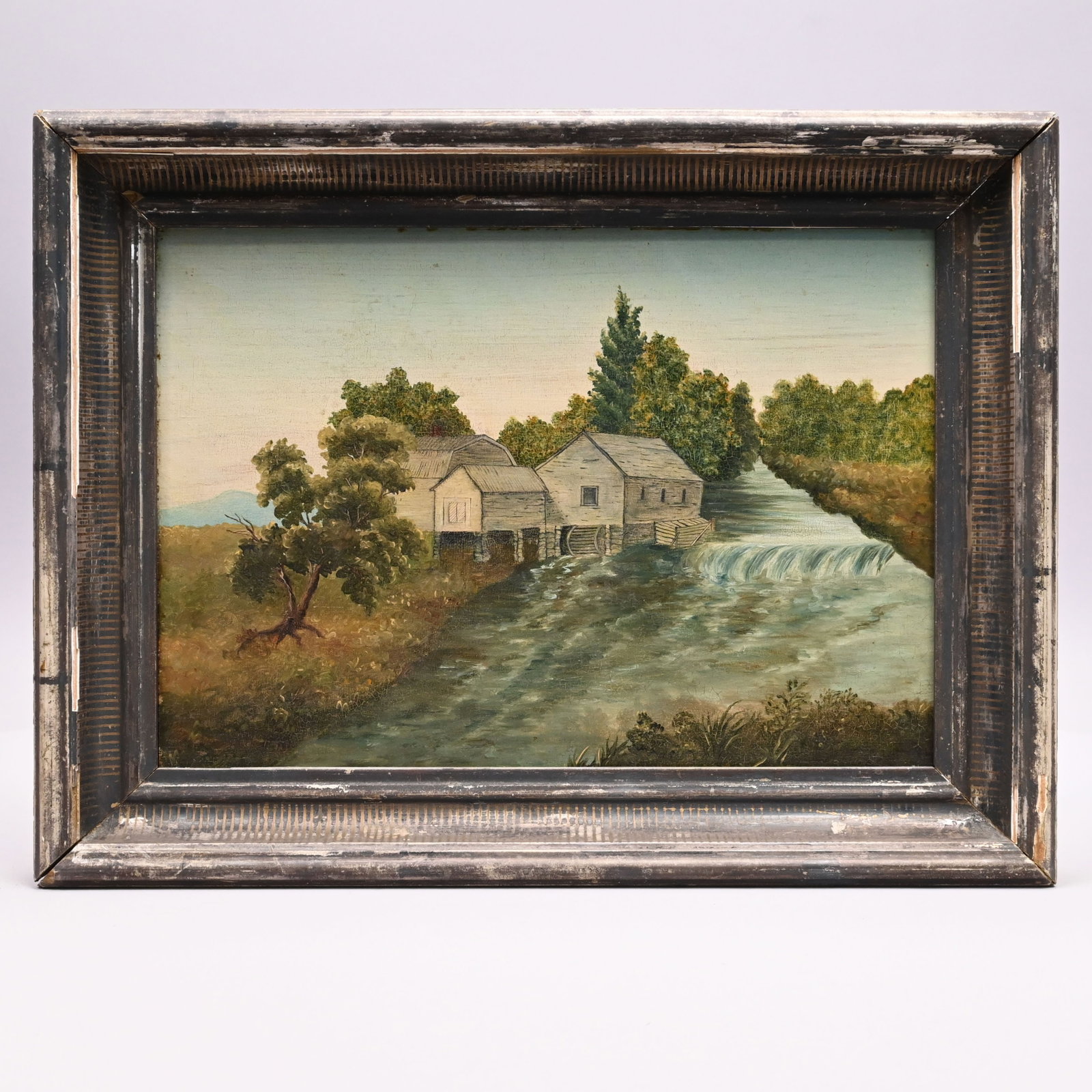 American School - Mill by the Stream: American School. Mill by the Stream, Nineteenth Century. Oil on board, depicting a waterwheel, machinery and storage buildings and a barn, apparently unsigned, (9.625 x 13.75 inches); housed in a peri