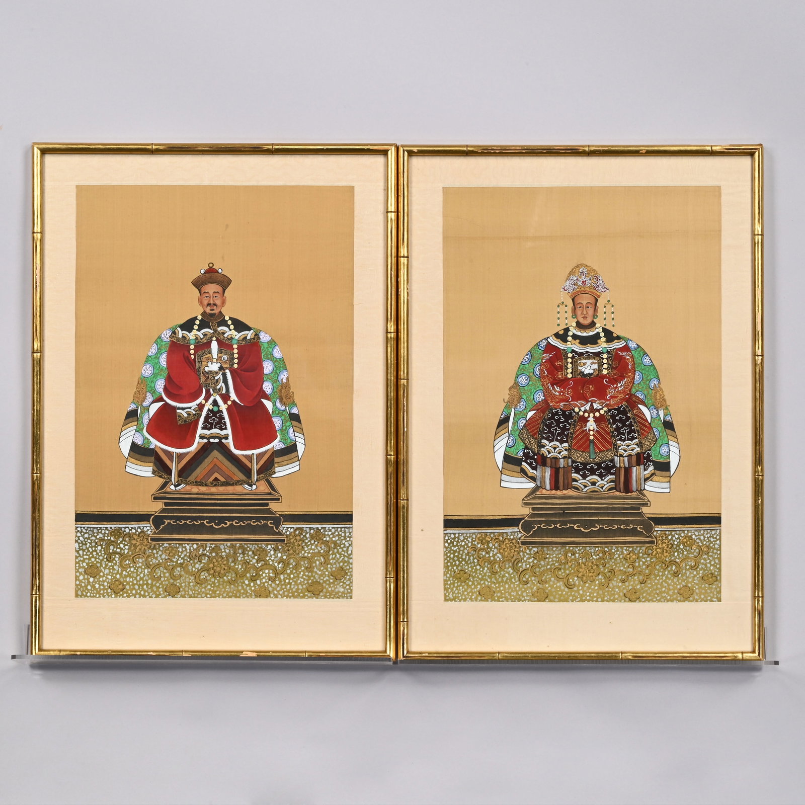 Pair of Chinese Ancestral Portraits: Pair of Chinese Ancestral Portraits. Ink and colors on brown raised line fibrous (bamboo?) paper, each attired in a formal red robe with a rank badge depicting a white crane or egret, (17.75 x 12 inch