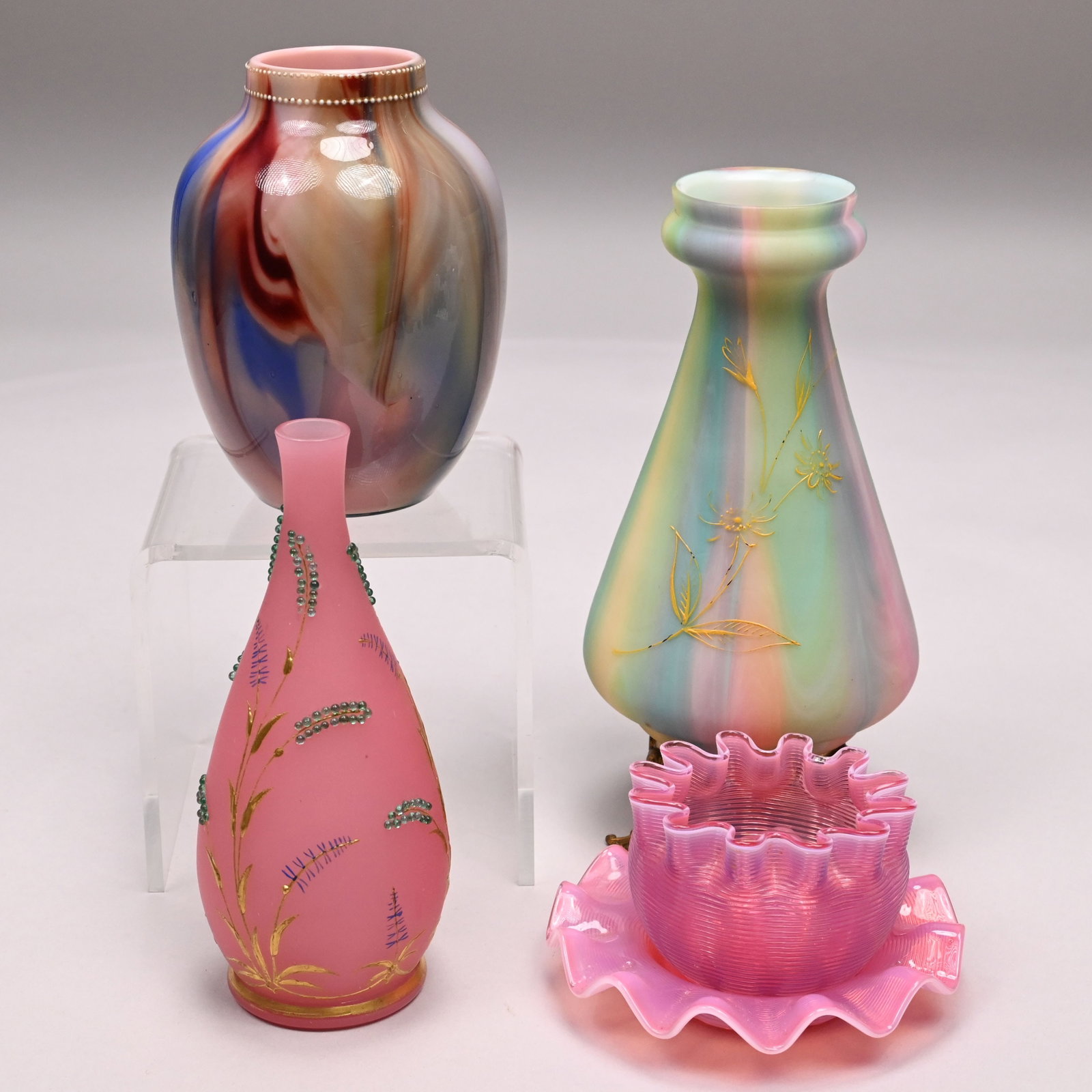 Four French, Bohemian & American Glass Wares: Three French or Bohemian Glass Vases and an American Finger Bowl and Liner, Late Nineteenth Century. Comprising an onyx glass vase in shades of pink, blue, yellow and green, lined in pink, unsigned; a