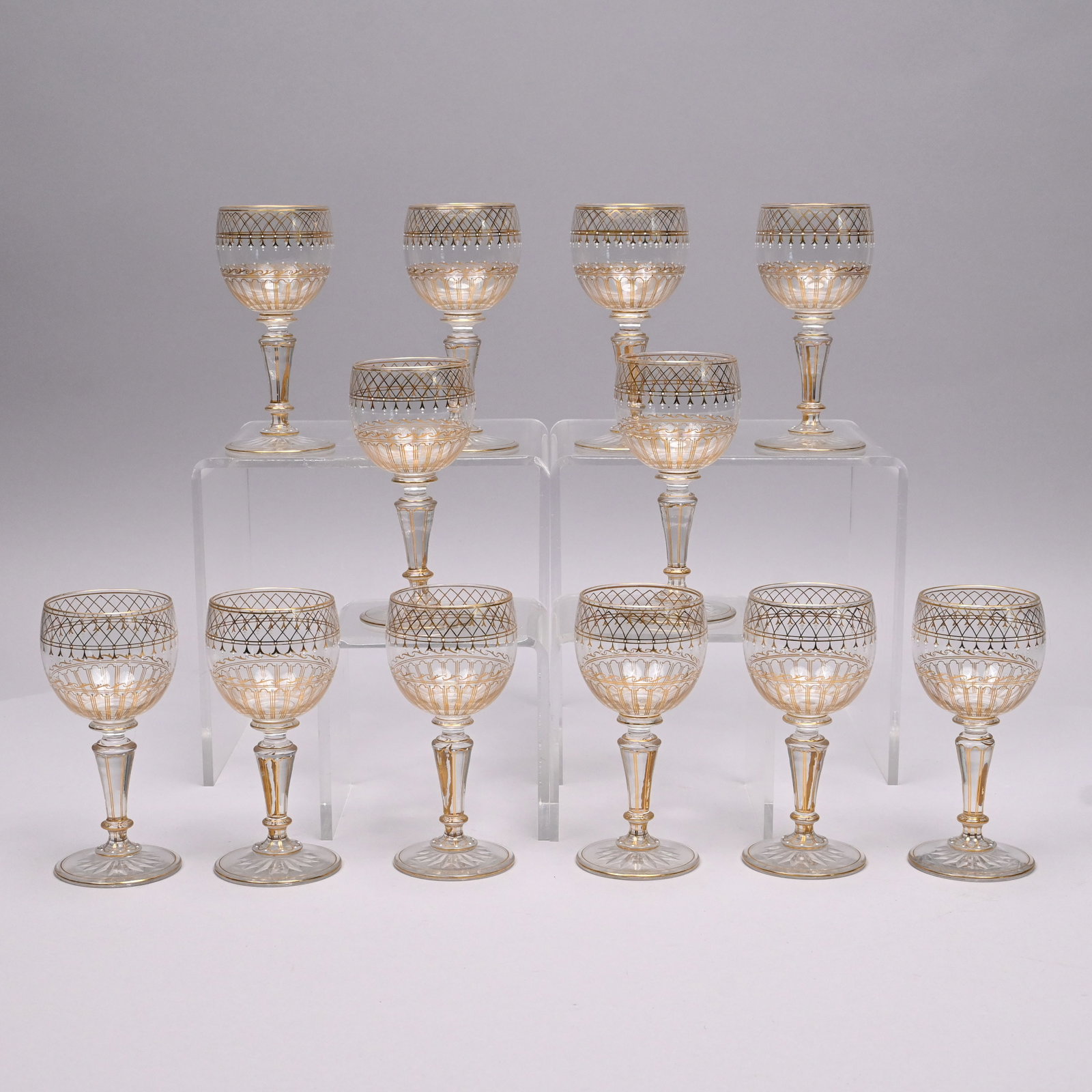Set Twelve Enamelled & Gilt-Decorated Wine Glasses: Set of Twelve Enamelled and Gilt-Decorated Wine Glasses, Late Nineteenth - Early Twentieth Century. Each bowl surrounded by overlapping lancet arches, Vitruvian scroll and panelled borders with white 