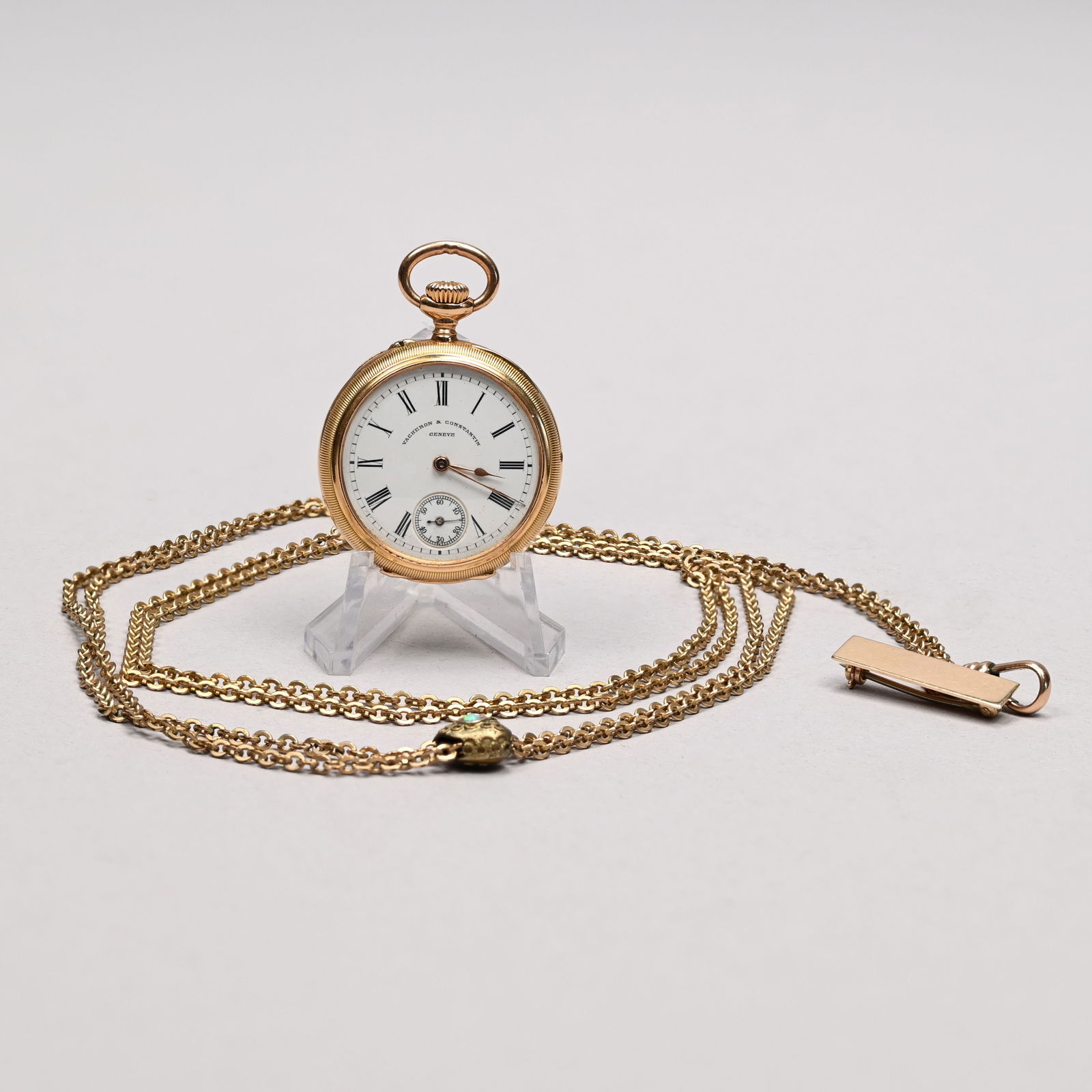 Swiss 18k Gold Ladies Watch, Vacheron & Constantin: Swiss 18k Yellow Gold Ladies Open Face Watch, Vacheron & Constantin, Geneva, and a Gold-Filled Chain. The watch serial number 188312, the dial with black Roman numerals, black outer minute track and s