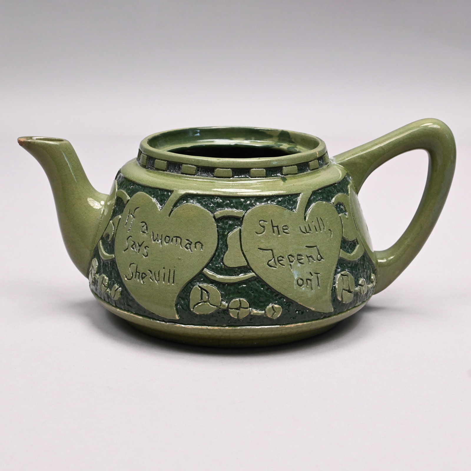 Roseville 'Rozane Della Robbia' Teapot, F. Rhead: Roseville Pottery Co. 'Rozane Della Robbia' Teapot, Designed by Frederick Hurton Rhead, Zanesville, Ohio, 1906 - 1907. Carved and glazed in two color green on dark green in a pattern of heart-shaped l