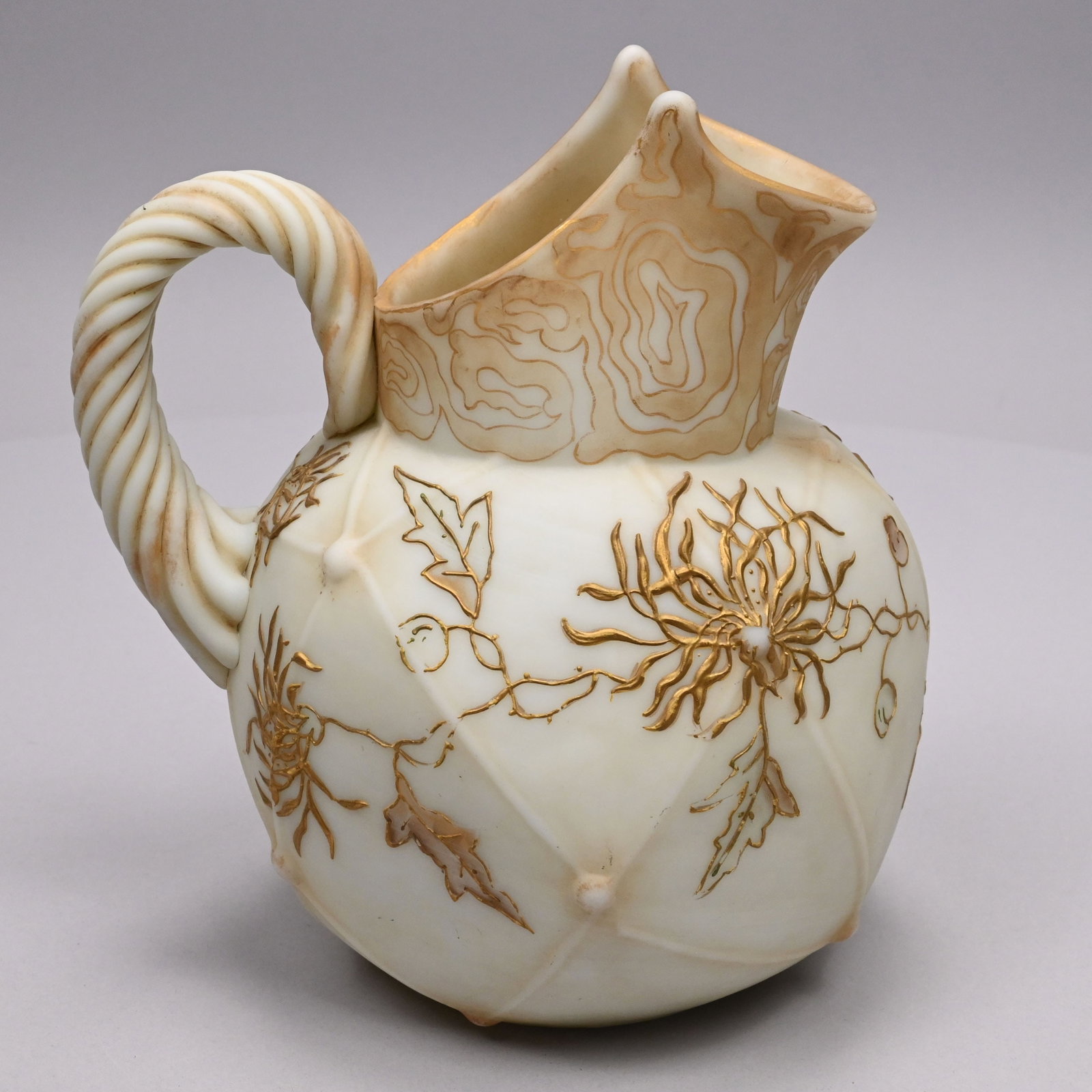 Mt. Washington Glass Co. 'Crown Milano' Pitcher: Mt. Washington Glass Co. 'Crown Milano' Water Pitcher, 1890 - 1895. Modelled in segmented panels with balls at the interstices, enamelled in raised gold with spider mums, the neck gilt in a tightly sc