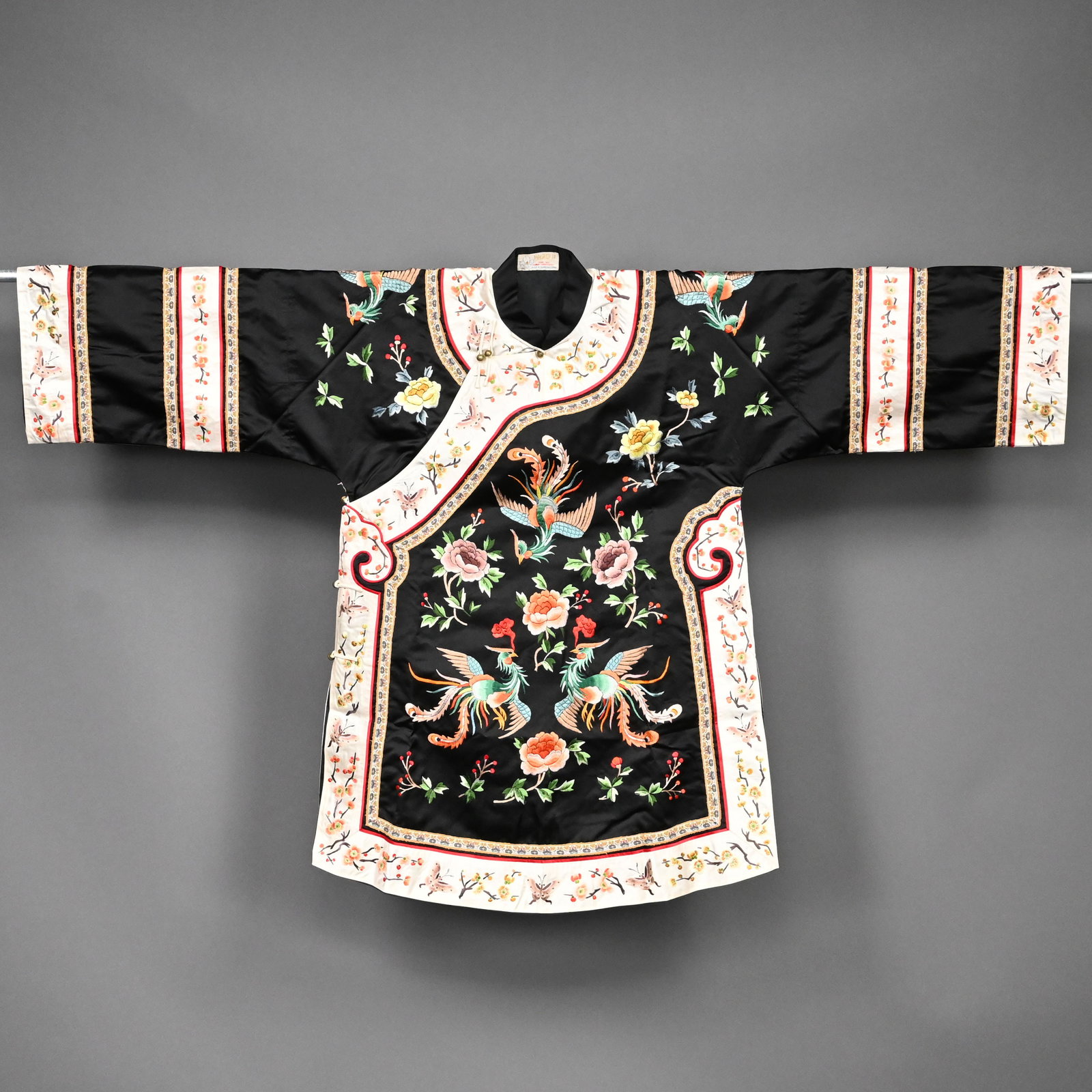 Chinese Silk Embroiderd Robe,Magnolia Co.,Shanghai: Chinese Ladies Silk Embroiderd Robe, Magnolia Company, Shanghai, Mid-Twentieth Century. Worked in shades of red, orange, green, blue, yellow and brown silk threads with three phoenixes on the front, t