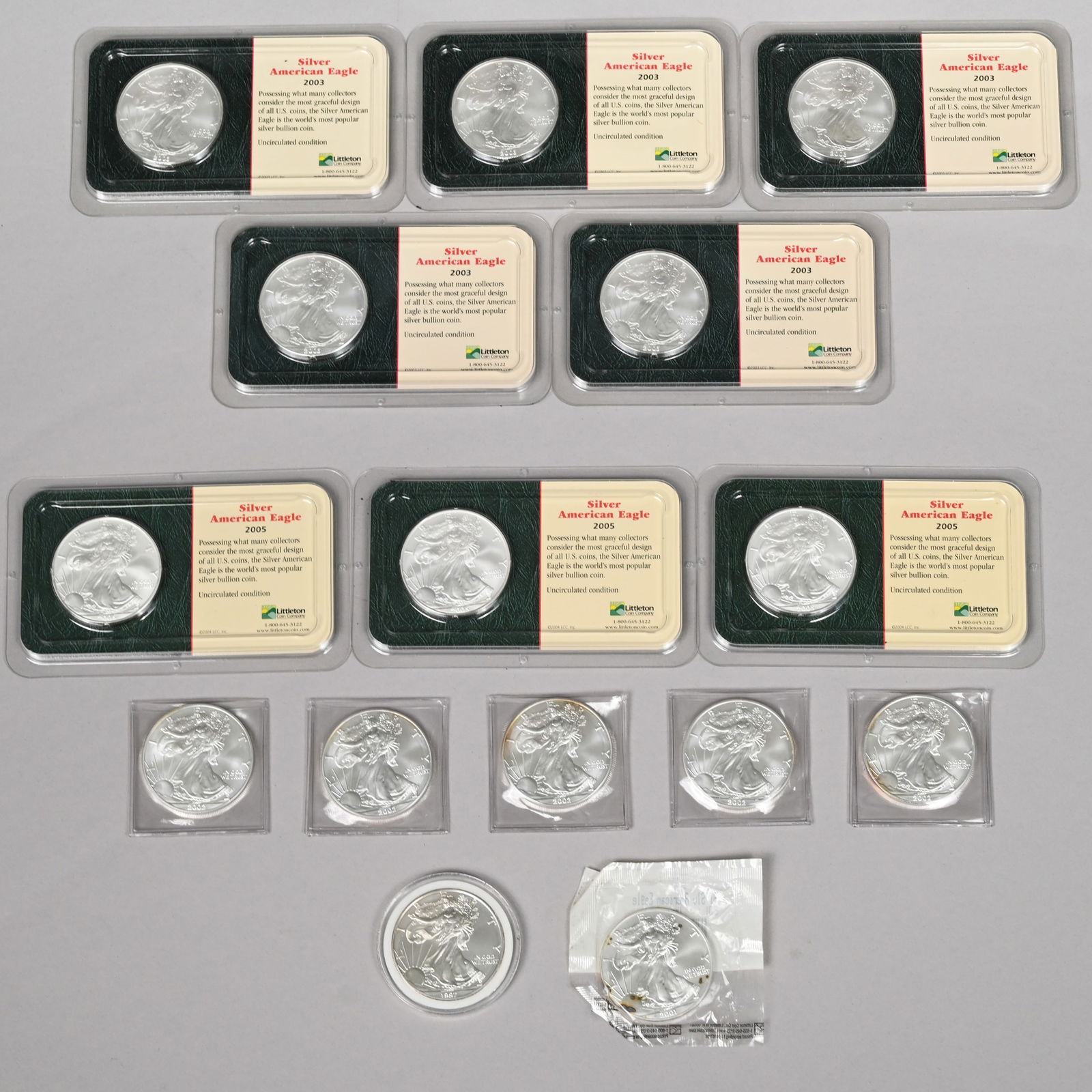 Fifteen US Silver American Eagle $1 Coins: Fifteen US Silver American Eagle $1 Coins, including 1997, 2001, 2002 (5), 2003 (5) and 2005 (3).