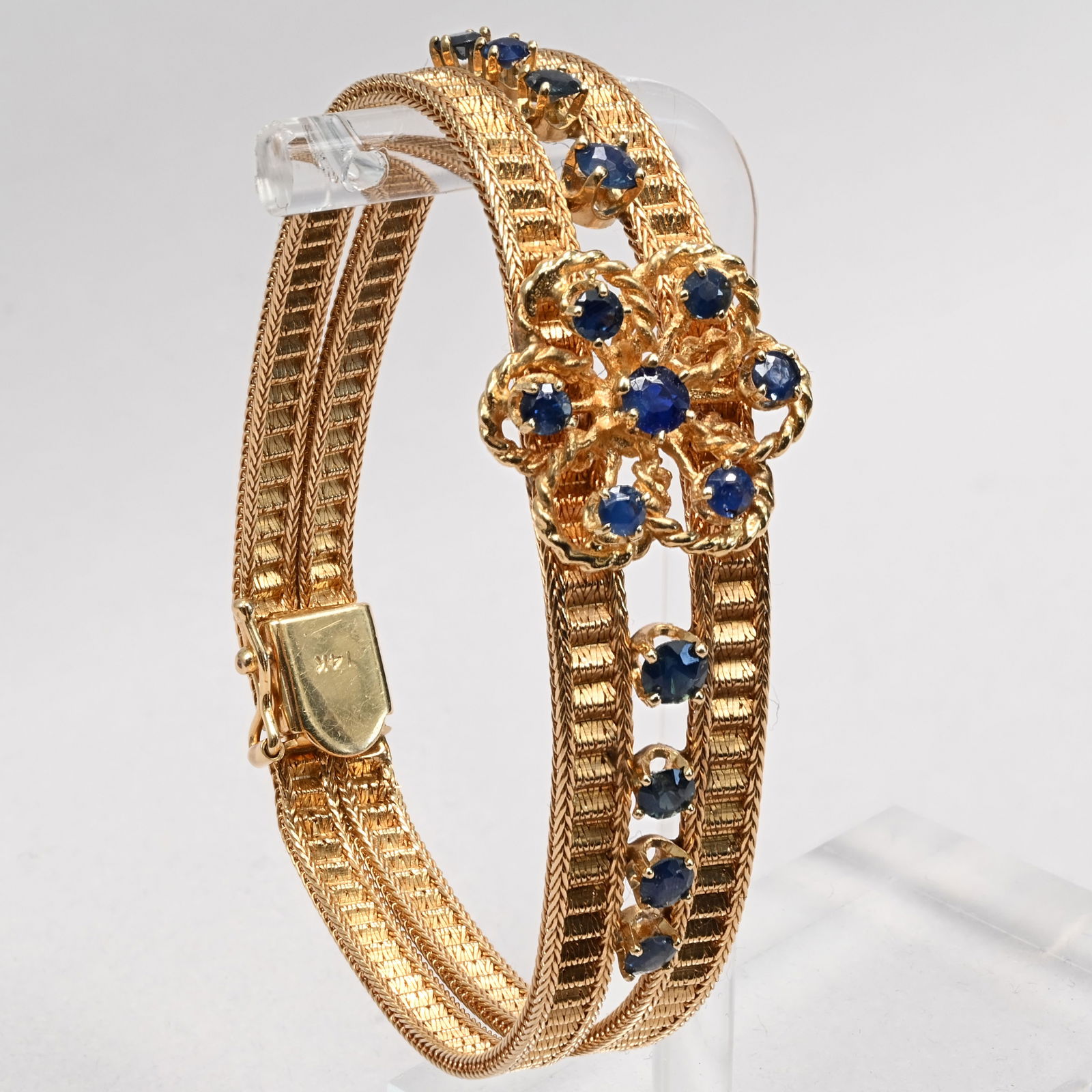 Ladies 14k Yellow Gold and Sapphire Bracelet: Ladies 14k Yellow Gold And Sapphire Bracelet. Of double row fine foxtail design, centering a flowerhead with seven prong-set sapphires, flanked by two rows of four sapphires, with box clasp.Total
