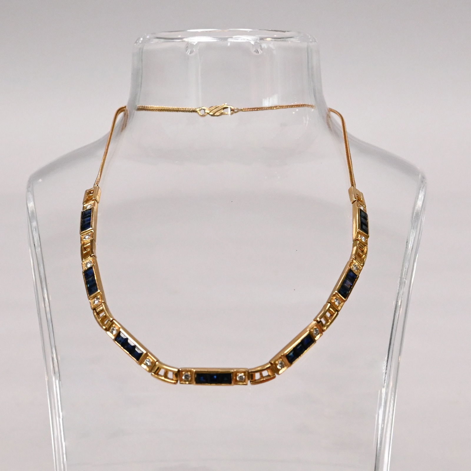 18k Yellow Gold, Diamond and Sapphire Choker: 18k Yellow Gold, Diamond and Sapphire Choker. Comprised of channel-set square-cut sapphires and melee diamonds, marked "750".21.1g total weightL: 14.5 in.