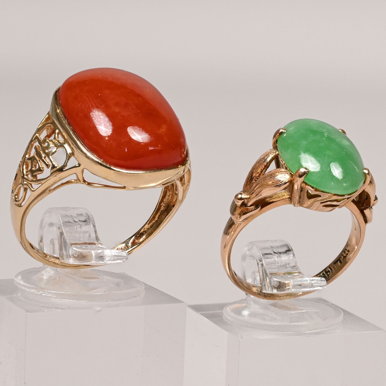 Ladies 14k Yellow Gold, Sapphire and Diamond Rings: Two Ladies 14k Yellow Gold Cabochon Rings. The first T.Y. Lee, Hong Kong, 1940s-1960s, with prong-set jadeite cabochon, the shoulders divided berried leaves, marked "T.Y.L./ 14k"; the second bezel-set