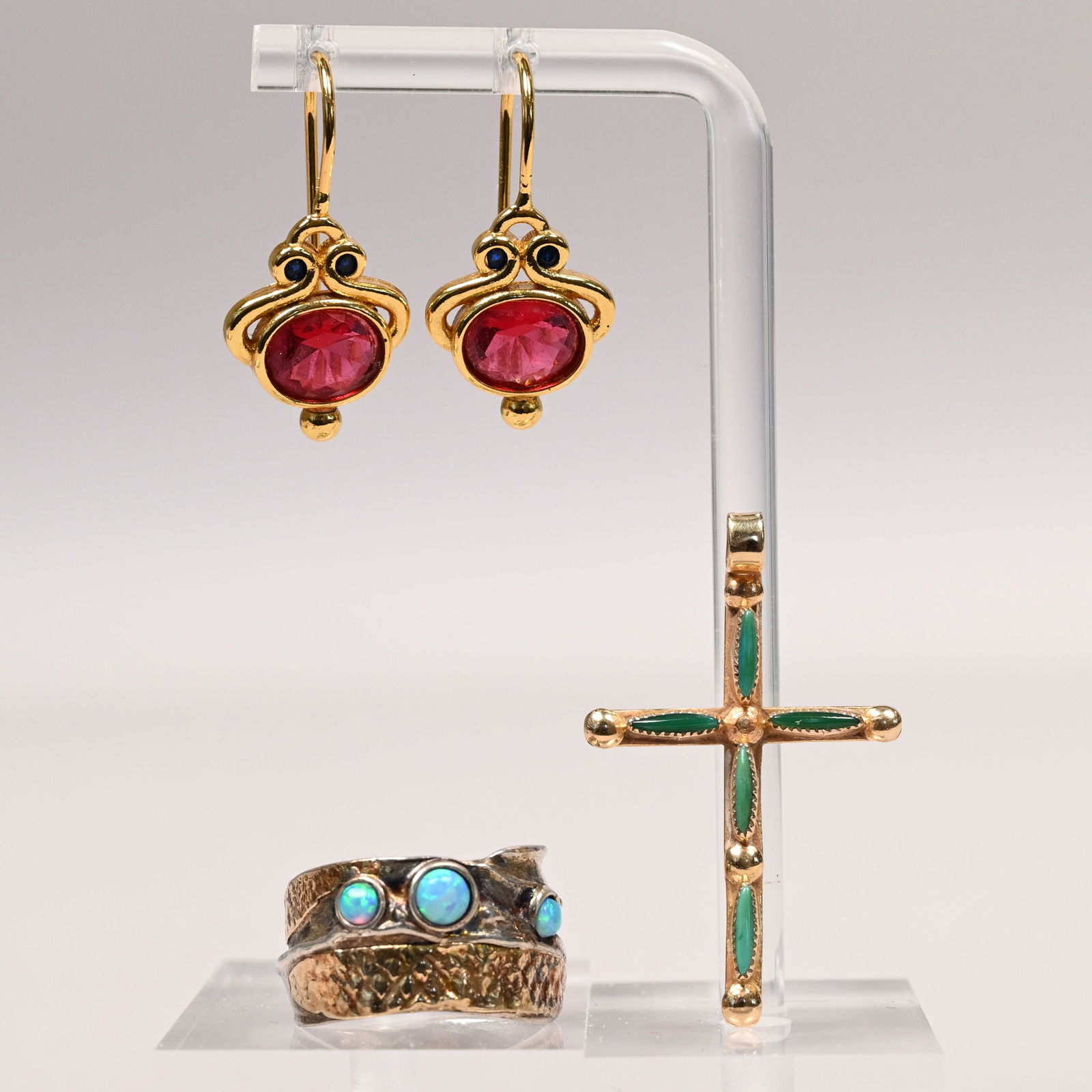 Group of Gold and Sterling Silver Jewelry: Group of Gold and Sterling Silver Jewelry. Comprising a sterling silver and 14k yellow gold ring, marked "925/ 14k" and "925" incuse; a 14k yellow gold jadeite-mounted crucifix, marked "14k"; and a