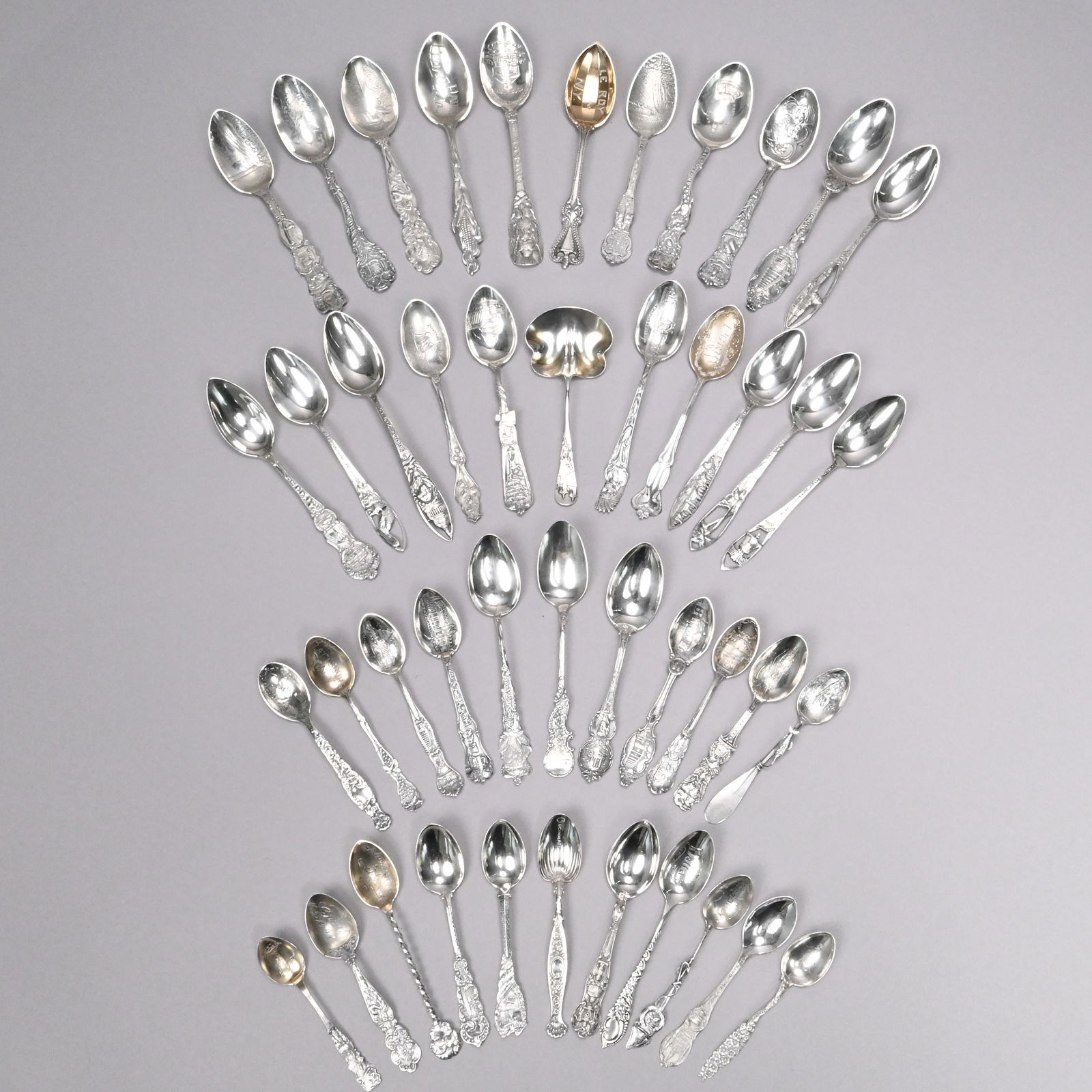 Large Group United States Silver Souvenir Spoons: Large Group of United States Silver and Silver-Gilt Souvenir Spoons, Various Makers, Late 19th-20th Century. Including an Old City Gate St. Augustine, Florida nut spoon, a Palm Beach, Florida spoon,