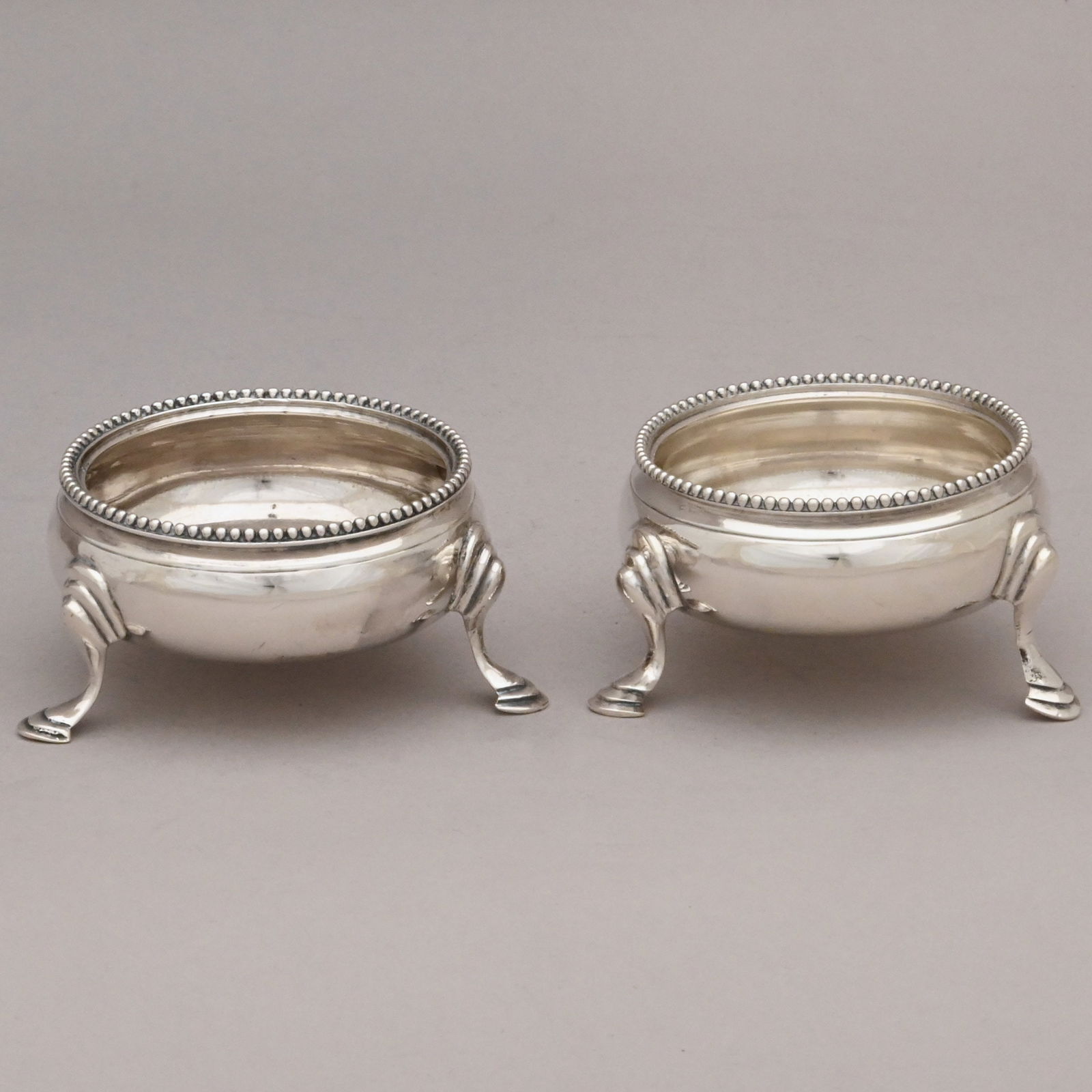 Pair George III Silver Salt Cellars, H. Bateman: Pair of George III Sterling Silver Salt Cellars, Hester Bateman, London, 1783. Each circular with applied beaded rim edge, raised on three hoof feet, not monogrammed, marked beneath.2.97 troy oz.