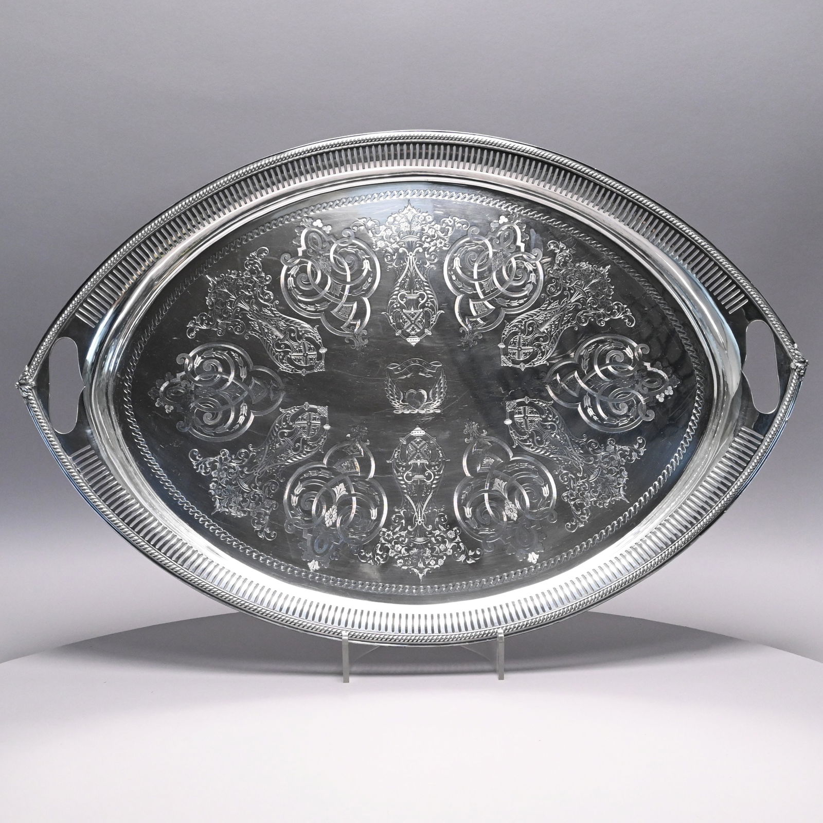 Victorian/ George V Silverplate Tray: Victorian/ George V Silverplate Tray, Possibly William Briggs & Co., 1875-1922. Engraved in the center with a heart between wings below the motto "SURSUM" (Upward), surrounded by six urns issuing spra