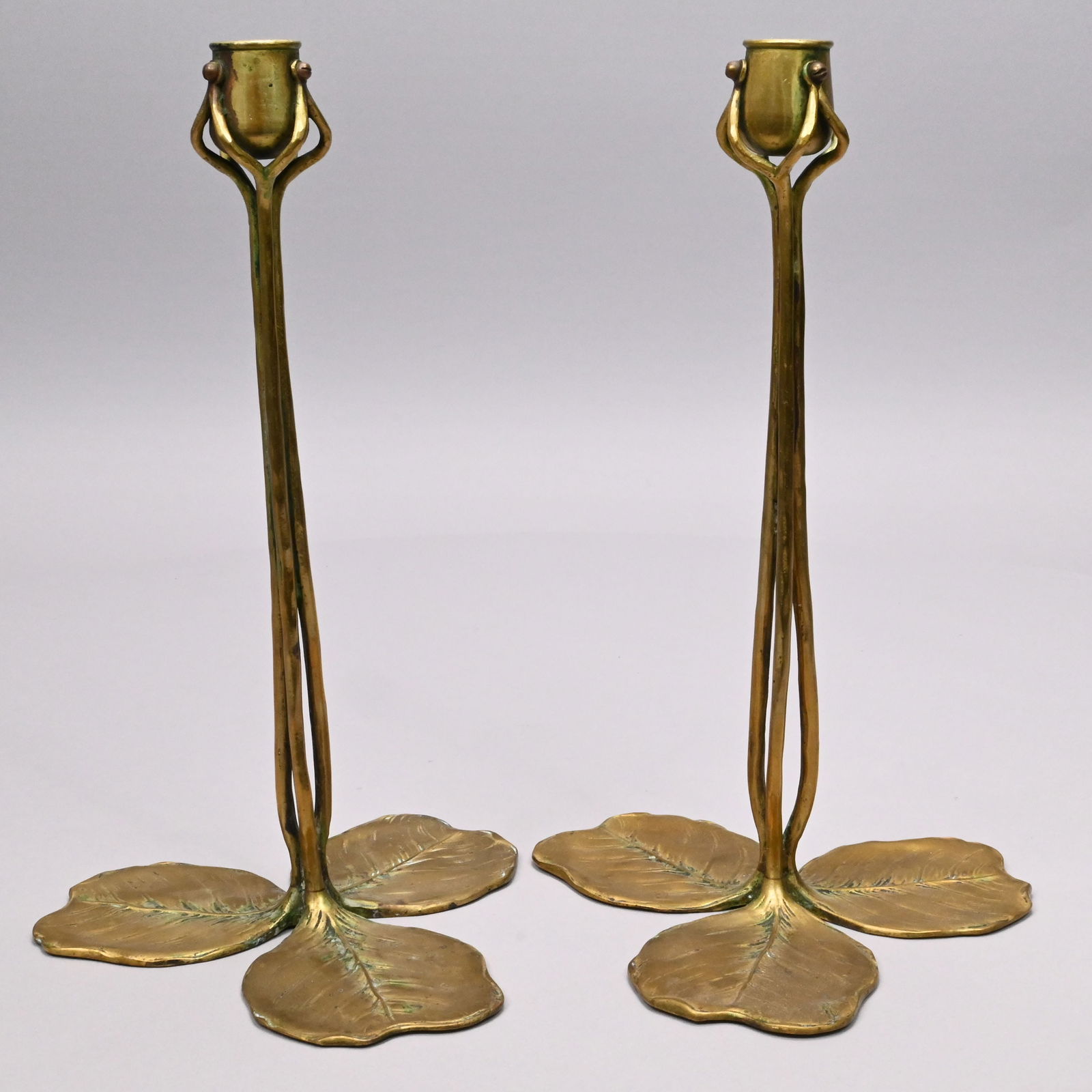 Pair of Jugendstil Brass Candlesticks, R. Muller: Pair of Jugendstil Gilt-Brass Candlesticks, Richard Muller (Dresden, 1874-1954) for K.M. Seifert & Co., Dresden-Lobtau, Germany, Circa 1900. Each clover leaf base issuing three stems, each dividing