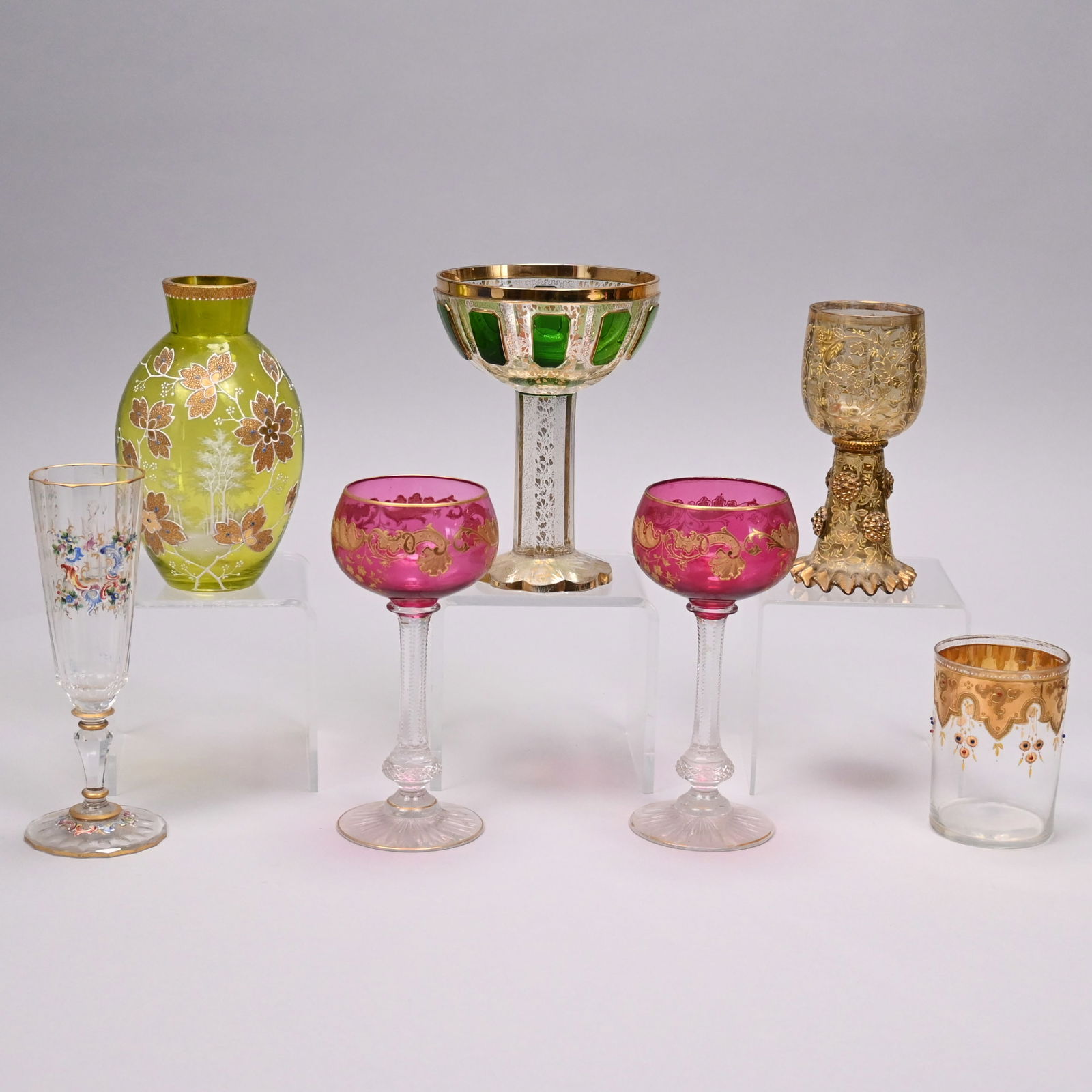 Seven Bohemian & Austrian Enamelled Glass Articles: Seven Bohemian and Austrian Cut, Enamelled and Gilt Glass Articles, Late 19th-Early 20th Century. Comprising a coralene vase, attributed to Ludwig Moser & Sons, 1890-1925, in pale yellow-green glass,