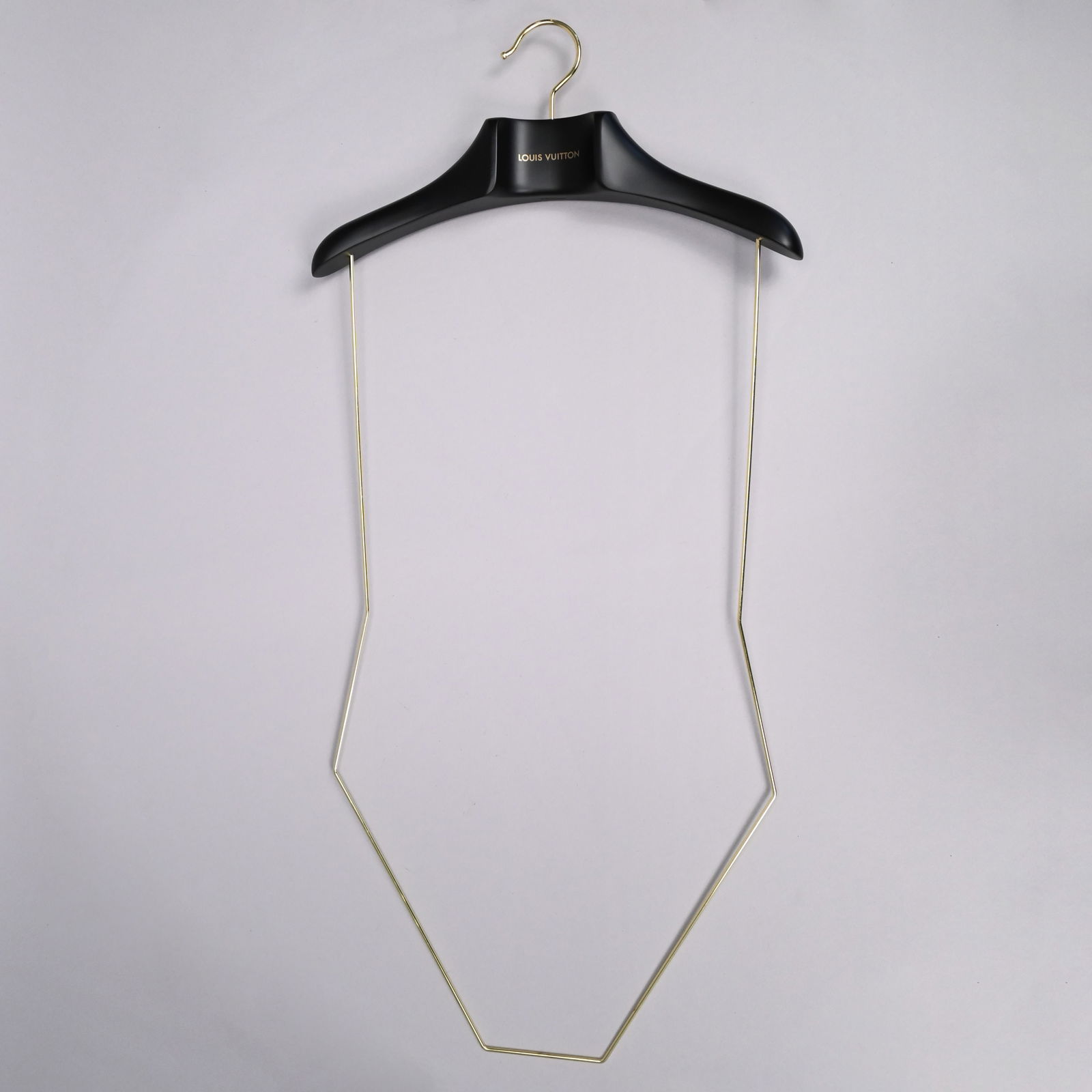 Fourteen Louis Vuitton Swimsuit Hangers: Fourteen Louis Vuitton Black Resin and Brass Swimsuit Hangers, 21st Century. Comprising ten one-piece hangers and four two-piece hangers, each swiveling and printed "LOUIS VUITTON" in gold letters on