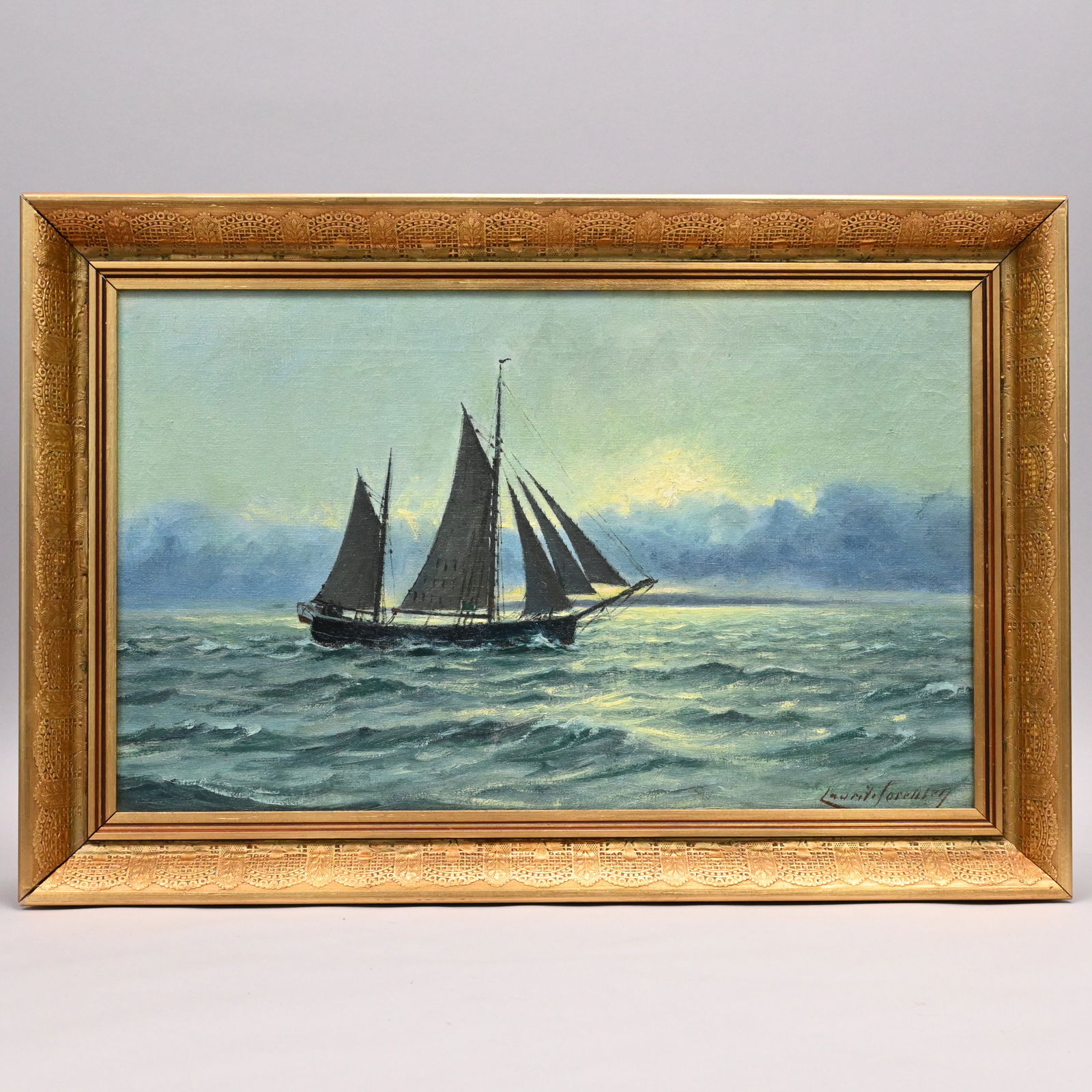 Lauritz Sorensen - Sailing at Sunset: Lauritz Sorensen (Danish 1882 - 1968). Sailing at Sunset. Oil on canvas, signed "Lauritz Sorensen" lower right, (12 x 19.75 inches).Frame: H: 15.25 in., W: 22.5 in., D: 2 in.