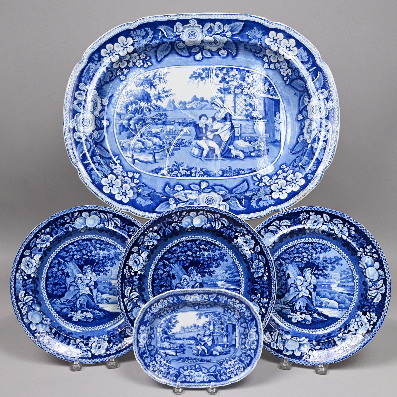 Five Staffordshire Blue Transfer-Printed Wares: Five Staffordshire Pearlware Blue Transfer-Printed Wares, 1814-1841. Comprising a "Blind Boy" oblong tureen stand and a well-and-tree platter, John & William Ridgway, 1814-1830, unmarked; and a set of