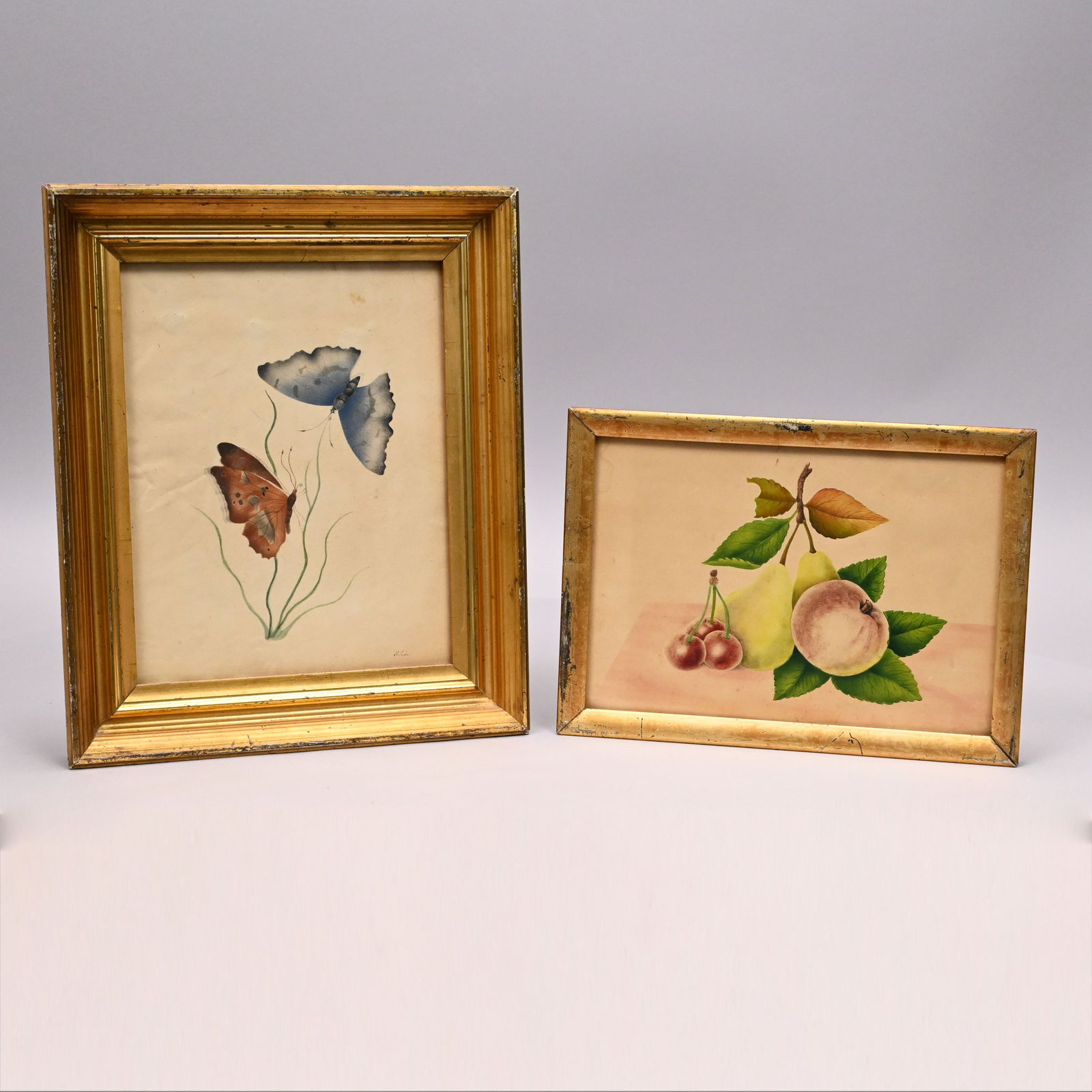 Two Small Watercolor Theorems: Two Small Watercolor Theorems. One a group of fruit, the other two butterflies, signed "Elise."Frame(s): H: 7.25 in., W: 10 in., D: 0.75 in. and H: 12 in., W: 10 in., D: 1.25 in.