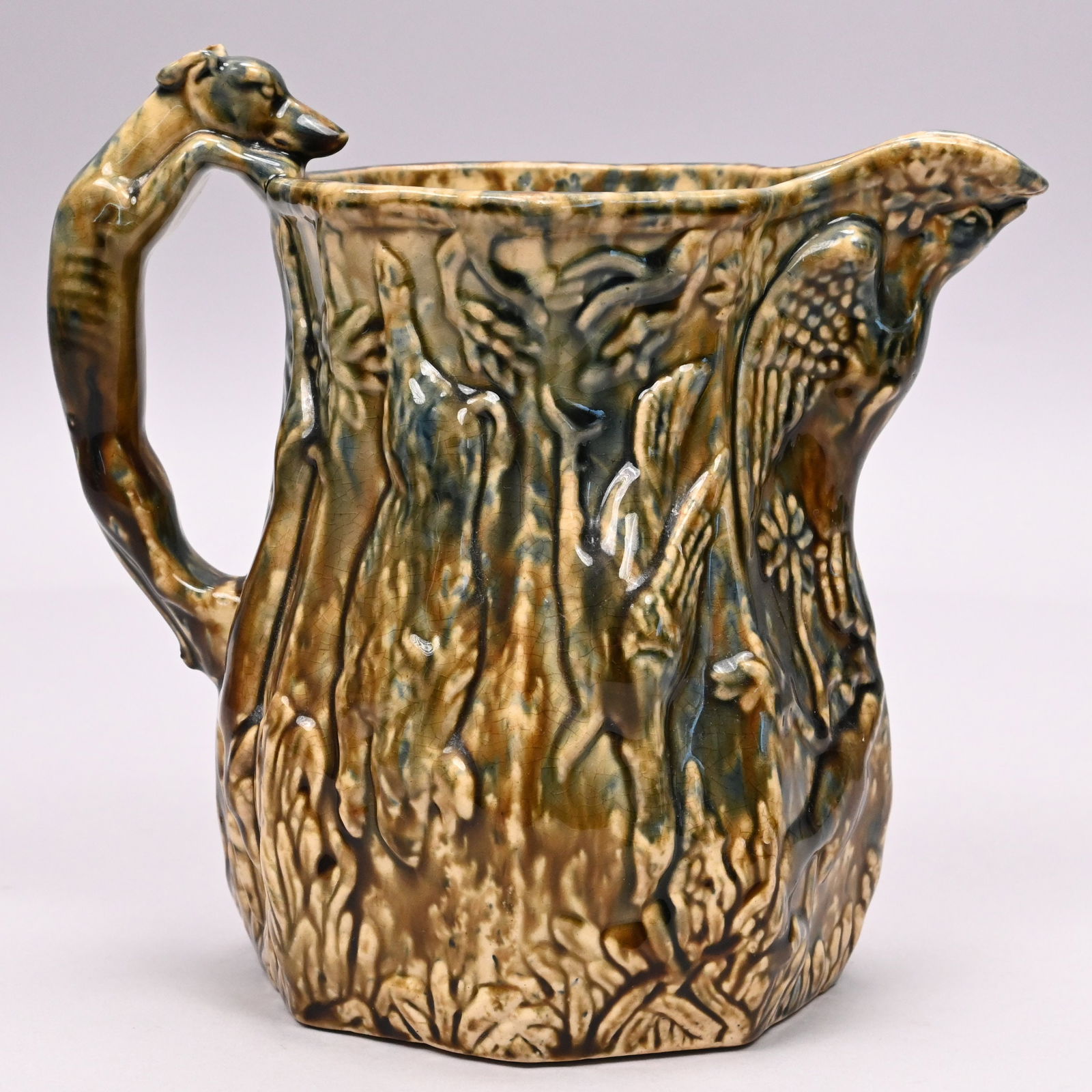 Patriotic Flint Enamel-Glazed Yellow Ware Pitcher: Patriotic Flint Enamel-Glazed Yellow Ware Pitcher, Possibly East Liverpool, Ohio, Mid-19th Century. Molded under the spout with a displayed eagle, the panelled sides molded with suspended game
