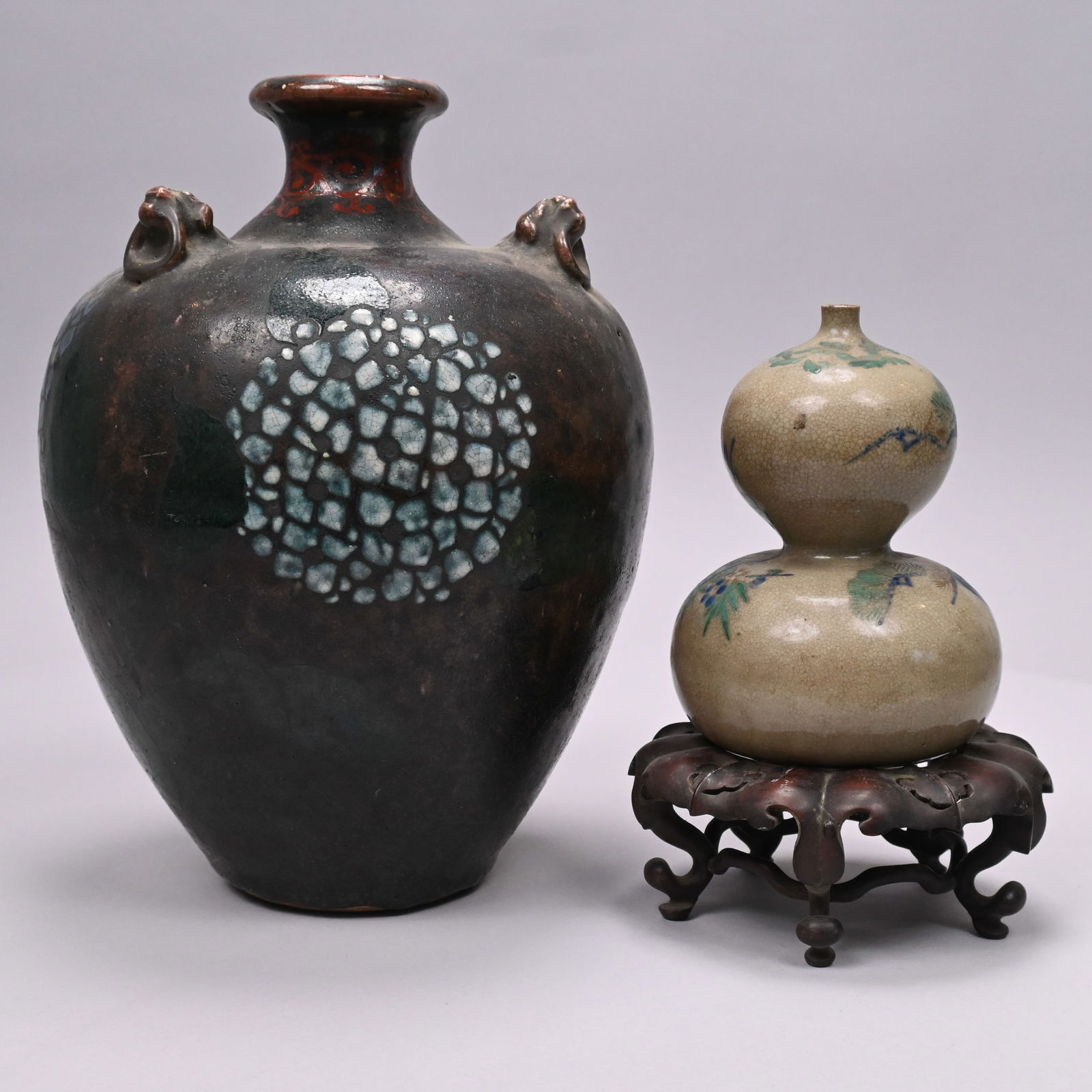Japanese Saki Bottle and a Glazed Pottery Vase: Japanese Painted Stoneware Saki (Tokkuri) Bottle and a Glazed Pottery Vase. The Kyoto ware saki bottle of double gourd form, painted in blue and green enamels and gilt with 'The Three Friends of
