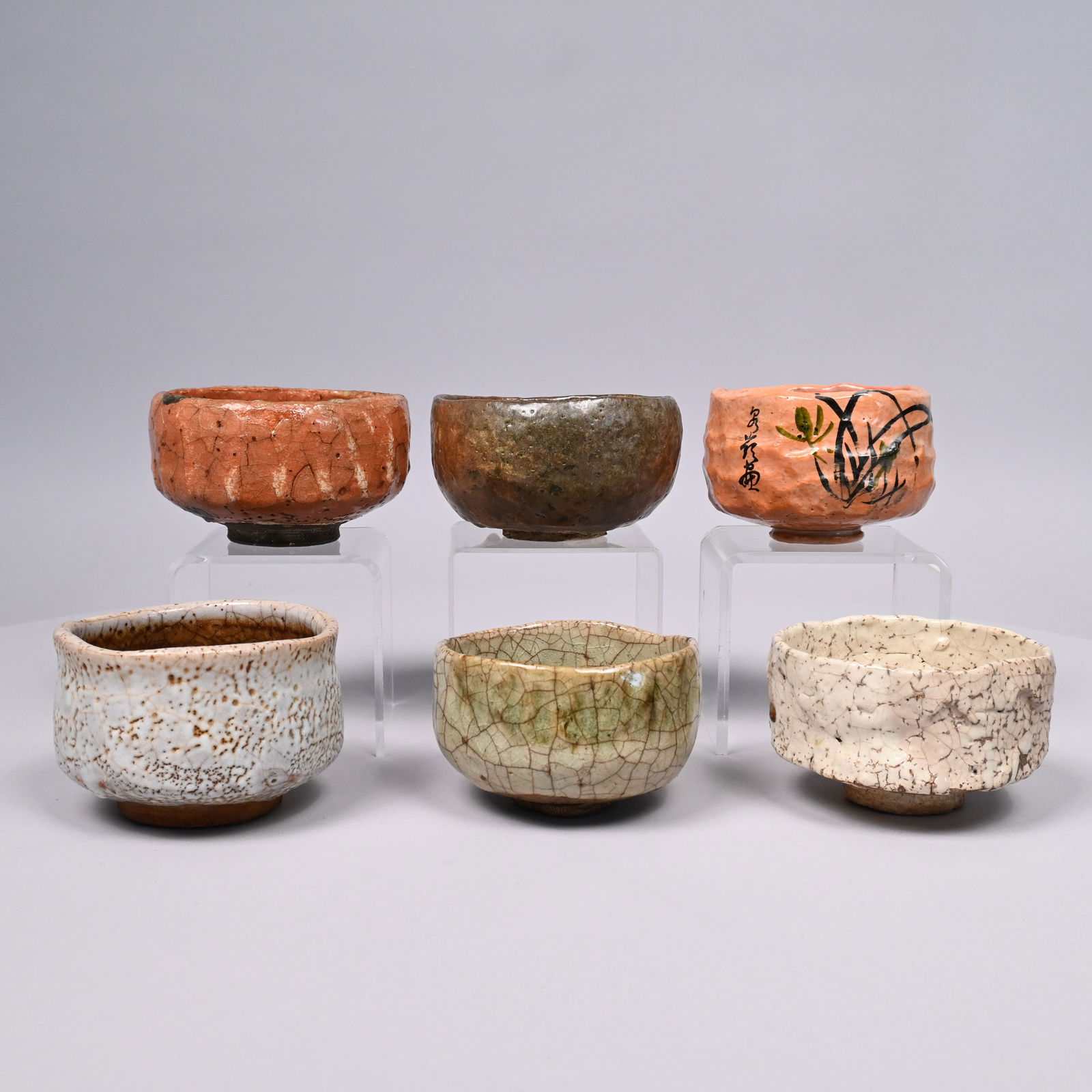 Six Japanese Glazed Earthenware Raku Bowls: Six Japanese Glazed Earthenware Raku Bowls, 20th Century. Some signed.Largest bowl: H: 2.875 in., Diam: 5.125 in.