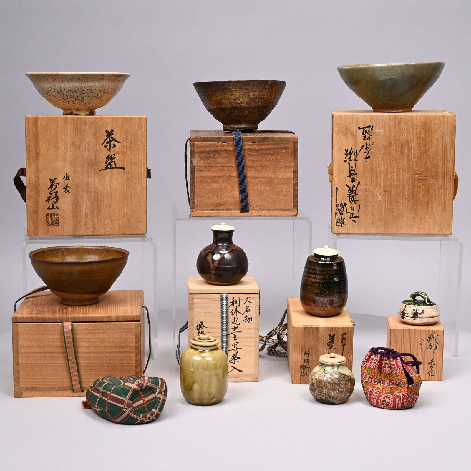 Nine Japanese Earthenware & Stoneware Articles: Four Japanese Glazed Earthenware and Stoneware Bowls, Four Tea Caddies and a Kogo (Incense Container), 20th Century. Some signed, seven each with an inscribed box.Largest box: H: 4.625 in., W: 7 in.,