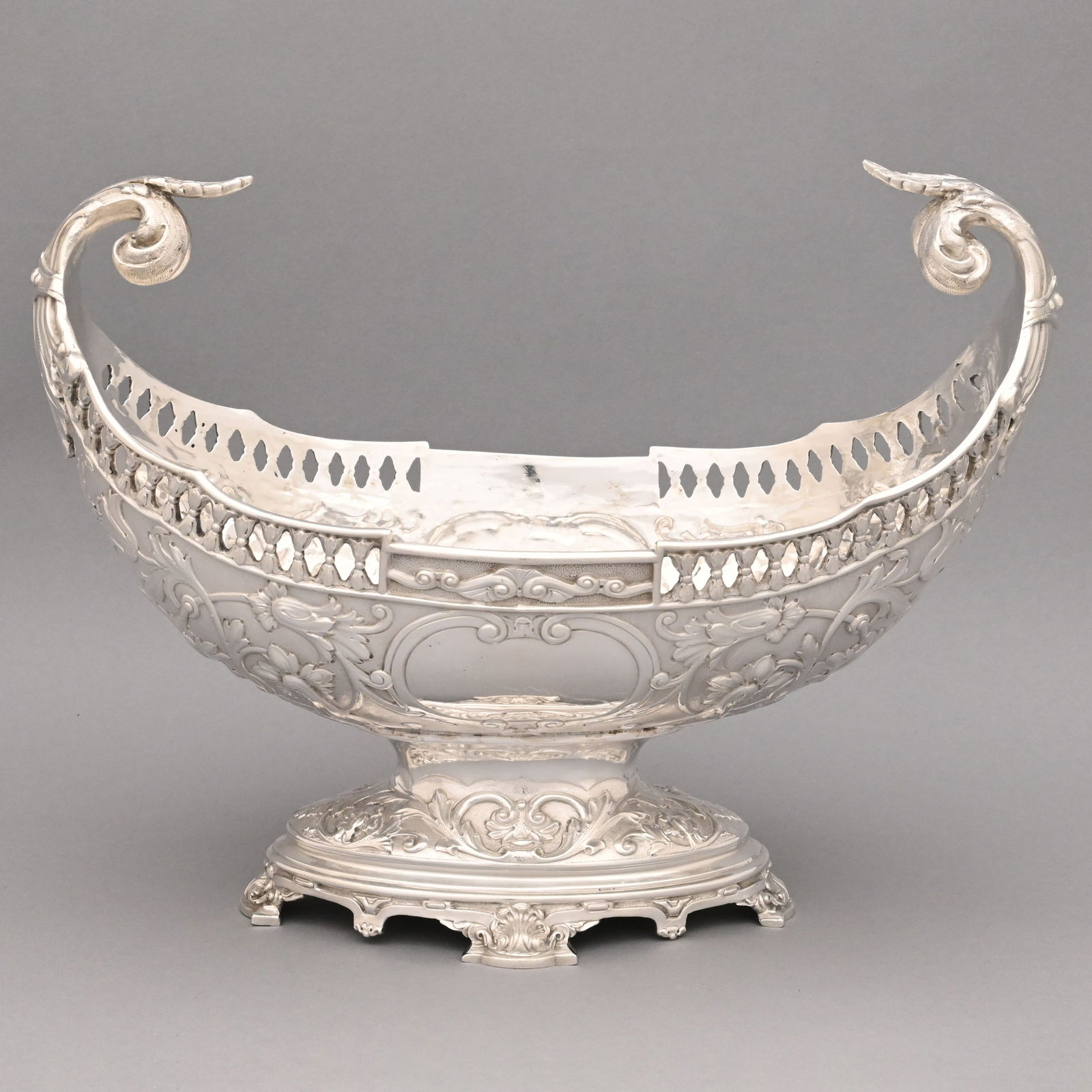 American Sterling Silver Fruit Centerpiece: American Sterling Silver Fruit Centerpiece, 19th Century.Chased and repousse with flowering hibiscus vines on a matte ground, reserved on each side with a vacant cartouche, the rim pieced with a