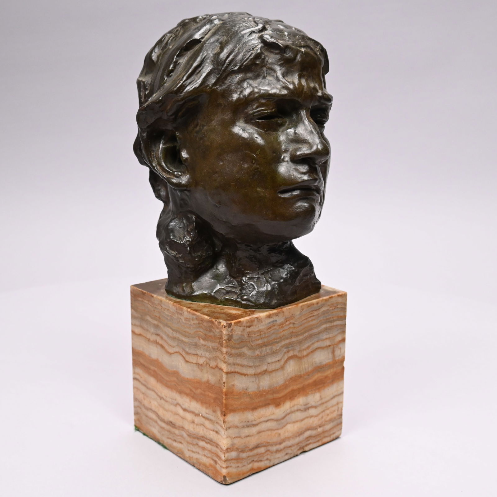 Auguste Rodin - "Tête de la Pleureuse": Auguste Rodin (French 1840-1917). "Tête de la Pleureuse (Head of the Weeping Woman)." Bronze with dark brown patina, (H: 8.25 inches), raised on a square onyx plinth, (overall H: 13 inches). Signed