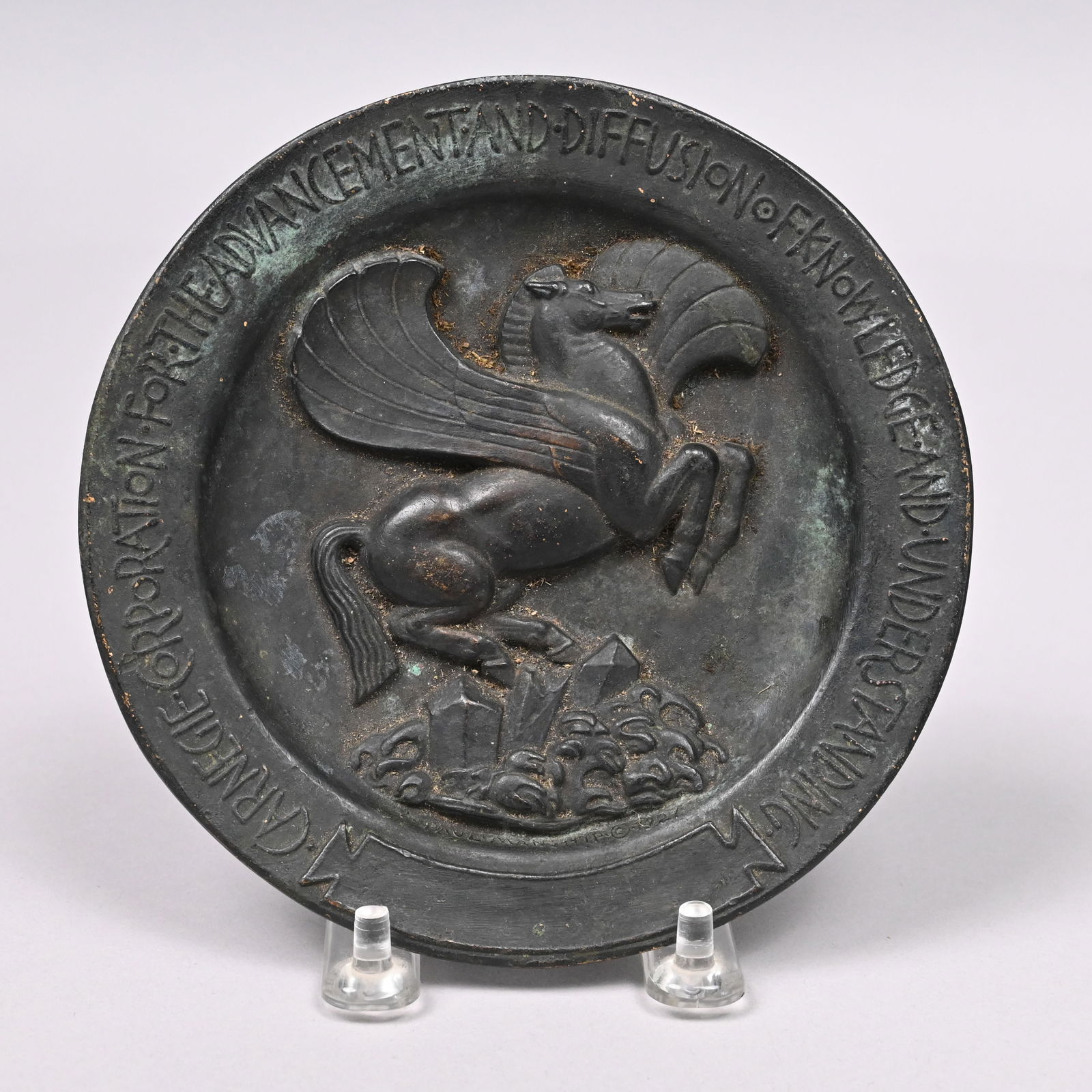 Paul Howard Manship - Bronze Pegasus Medallion: Paul Howard Manship (American, 1885-1966). Pegasus Medallion Commissioned by the Carnegie Corporation. In dark brown patina with some verdigris, cast with a view of the horse striking his hoof on the