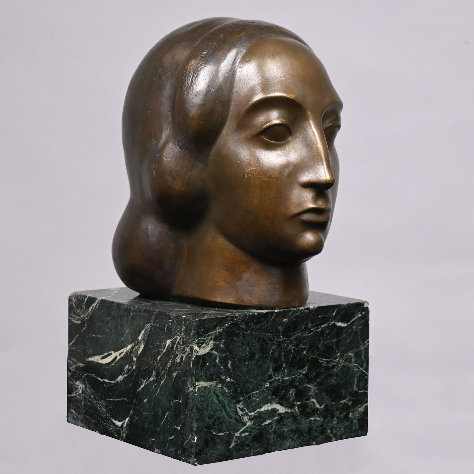 Gaston Lachaise - "Head of a Woman": Gaston Lachaise (French/ American, 1882-1935). "Head of a Woman," Patinated-Bronze. In selectively applied medium green-brown and dark brown patina, signed "G LACHAISE" and foundry mark "R.B.W." for