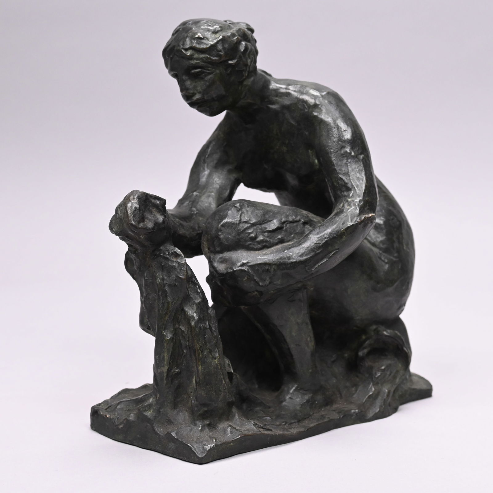La Petite Laveuse - After Pierre-Auguste Renoir: La Petite Laveuse, After Pierre-Auguste Renoir (French, 1841-1919). Patinated-Bronze Figure of a woman Washing Clothes. In dark verdigris patina, signed "Renoir" on base, no foundry mark.H: 10 in.,