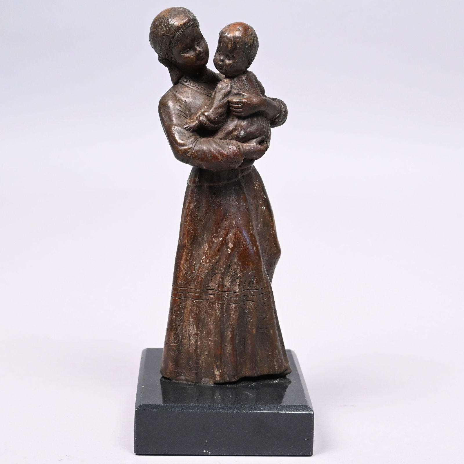 Continental Bronze Figural Group of Mother & Child: Continental Bronze Figural Group of a Mother and Child. In brown patina, attired in Russian or Ukrainian traditional peasant costume, unsigned, mounted on a slate base.Bronze: H: 7.5 in.Overall: H: