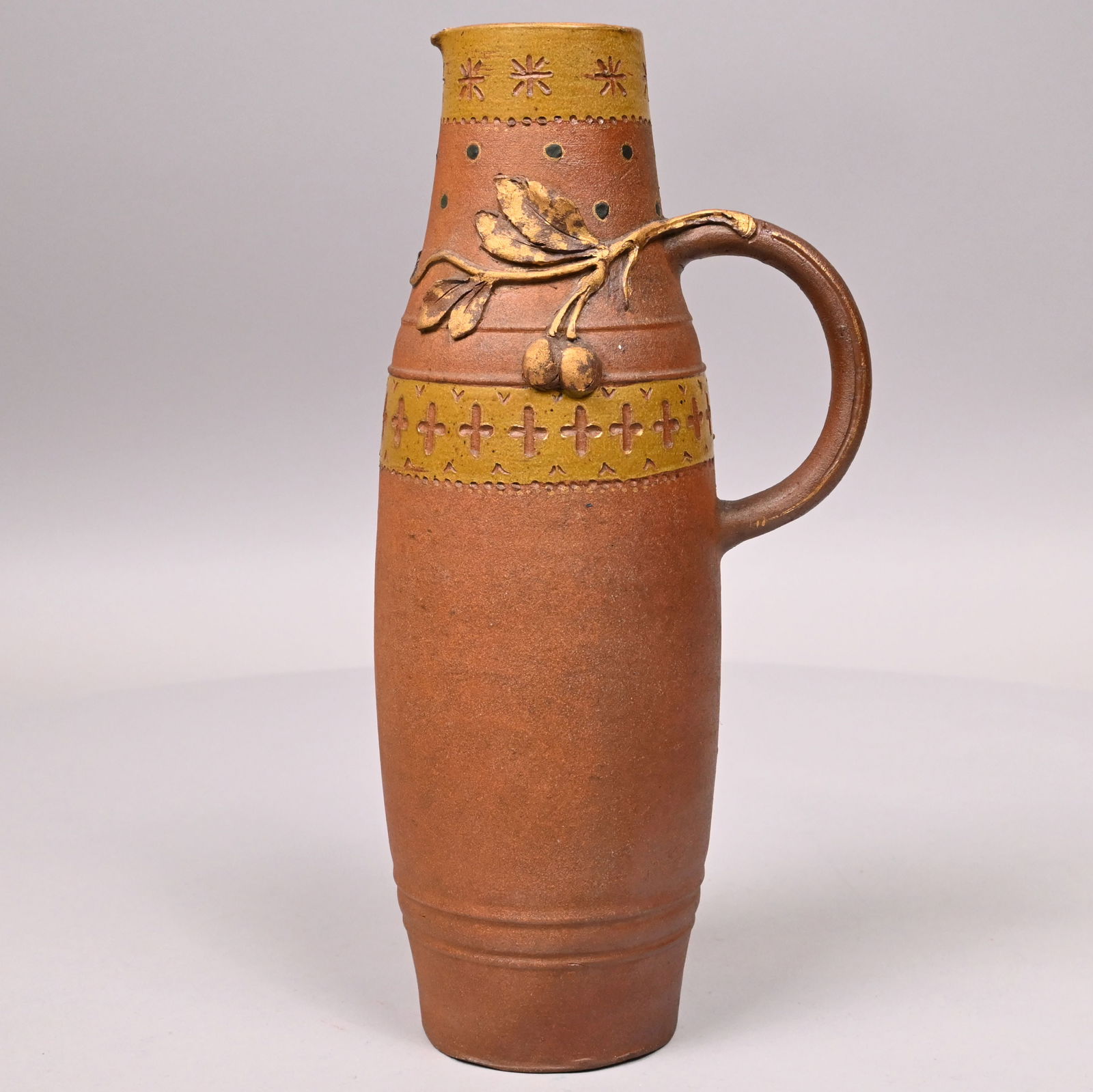 Ernest Chaplet, Haviland and Co. Stoneware Ewer: Ernest Chaplet for Haviland and Co. Glazed Stoneware Ewer, French, Circa 1885. Of tall bulbous form, the scroll handle issuing branches onto each side, one bearing cherries and leaves, surrounded by