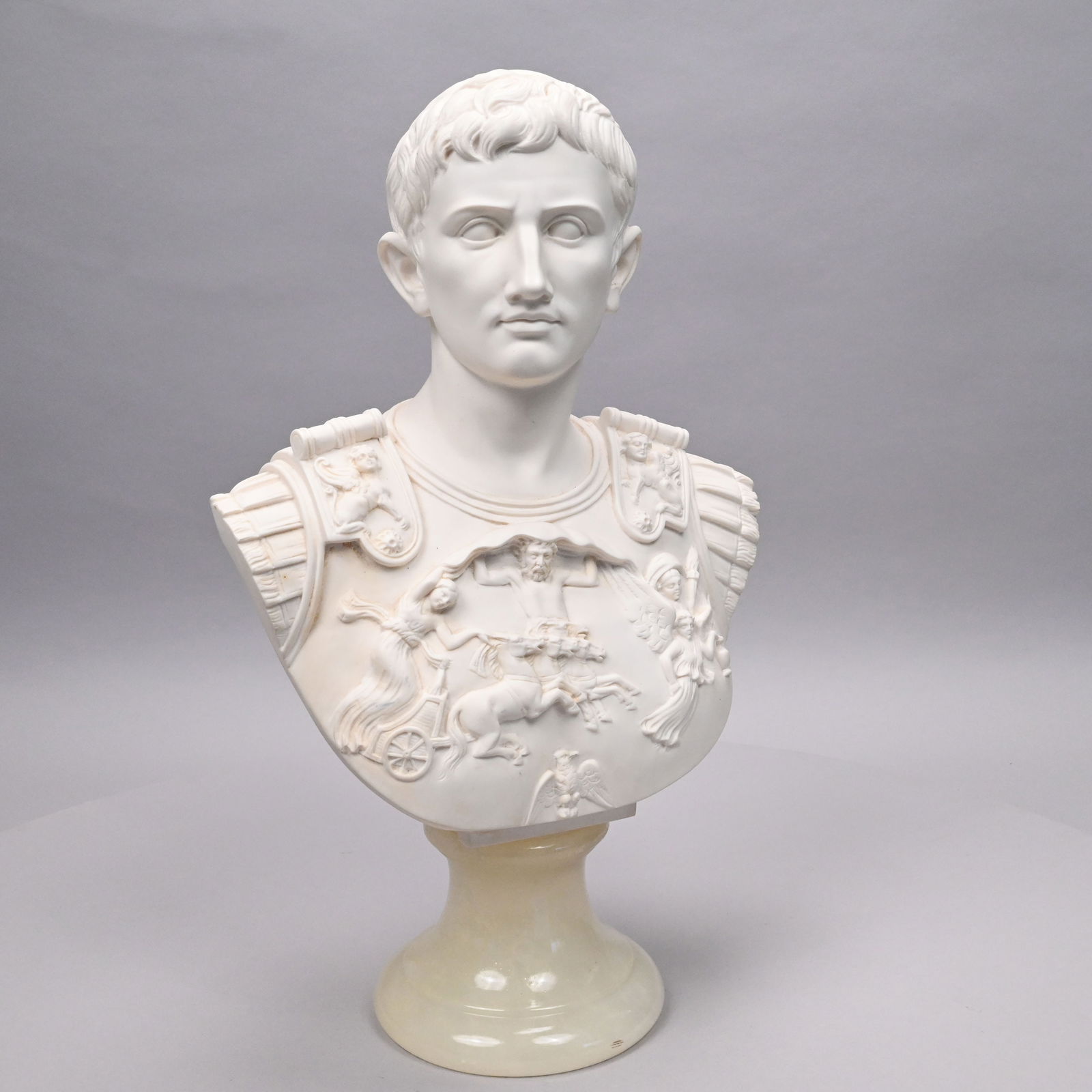 After Giuseppe Bessi - Bust of Caesar Augustus: After Giuseppe Bessi (Italian, 1857-1922). Stonelite (Composite) Bust of Caesar Augustus. Incised "Prof G. Bessi" at the base on the reverse, mounted on a faux alabaster circular base.H: 19.875 in.,