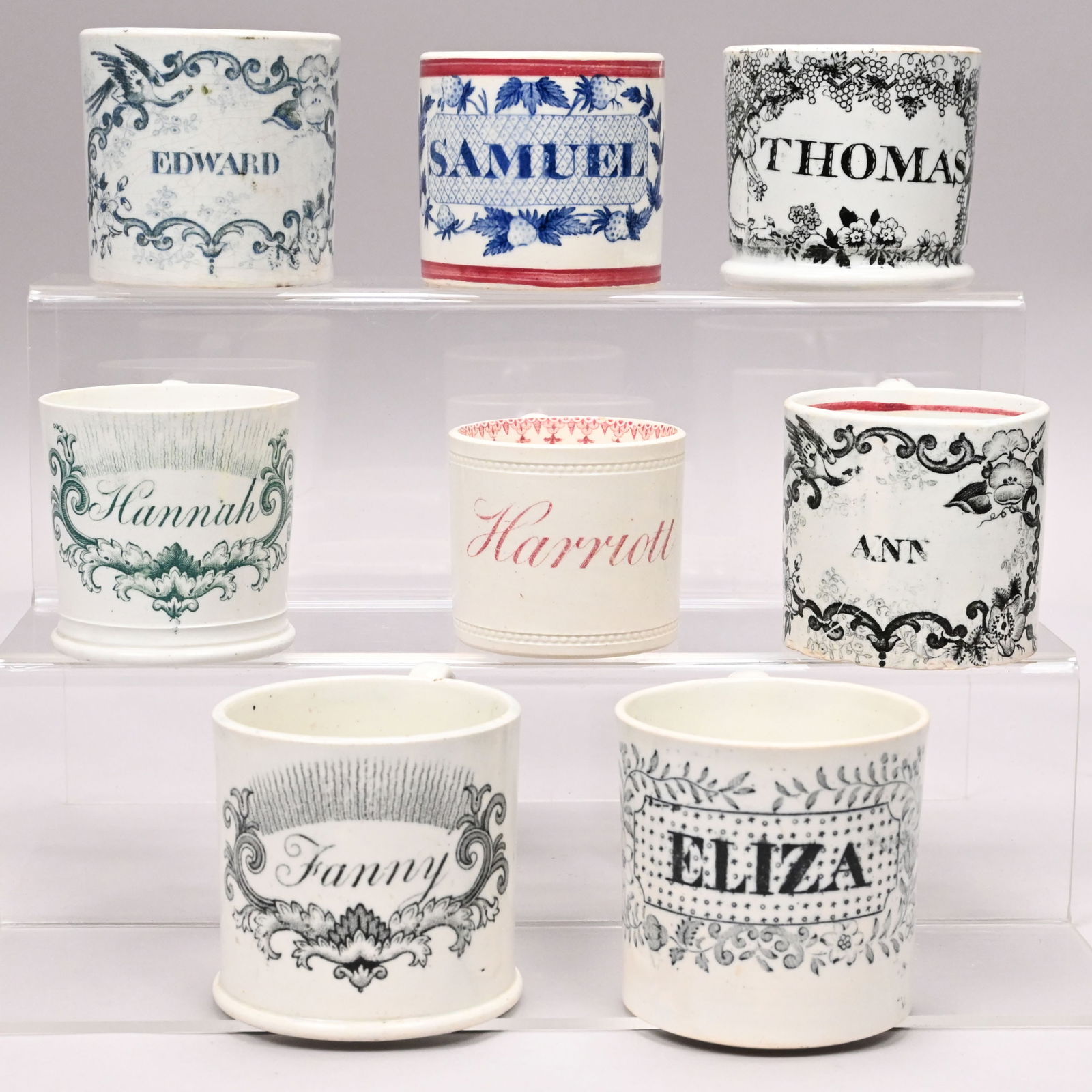 Eight Staffordshire Printed Named Children's Mugs: Eight Staffordshire Transfer-Printed Named Children's Mugs, 1830-1850. Comprising a creamware mug for "Harriett;" and seven mugs for "ANN", "EDWARD", "ELIZA", "Fanny", "Hannah", "SAMUEL" and